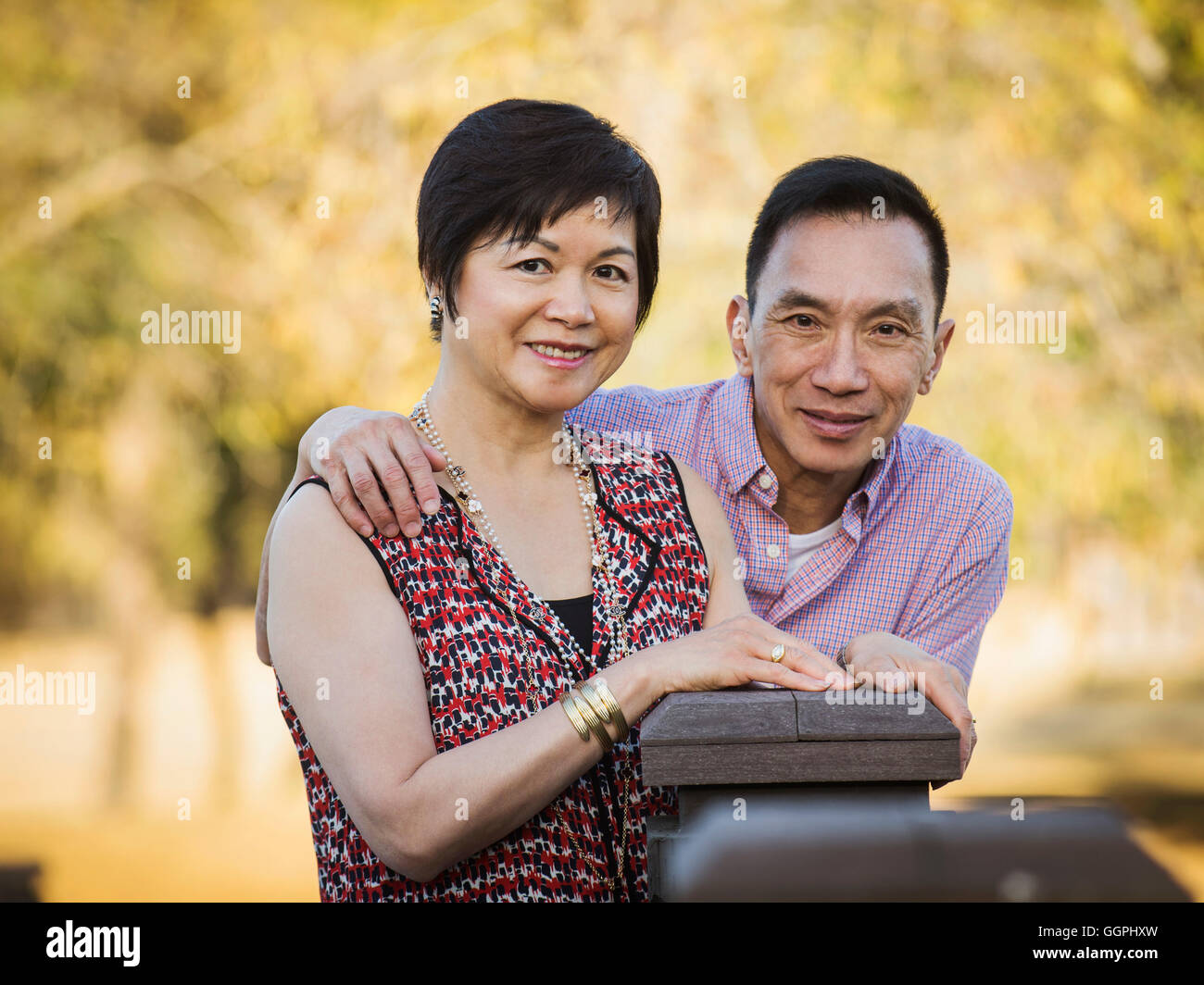 Older Chinese couple smiling outdoors Stock Photo
