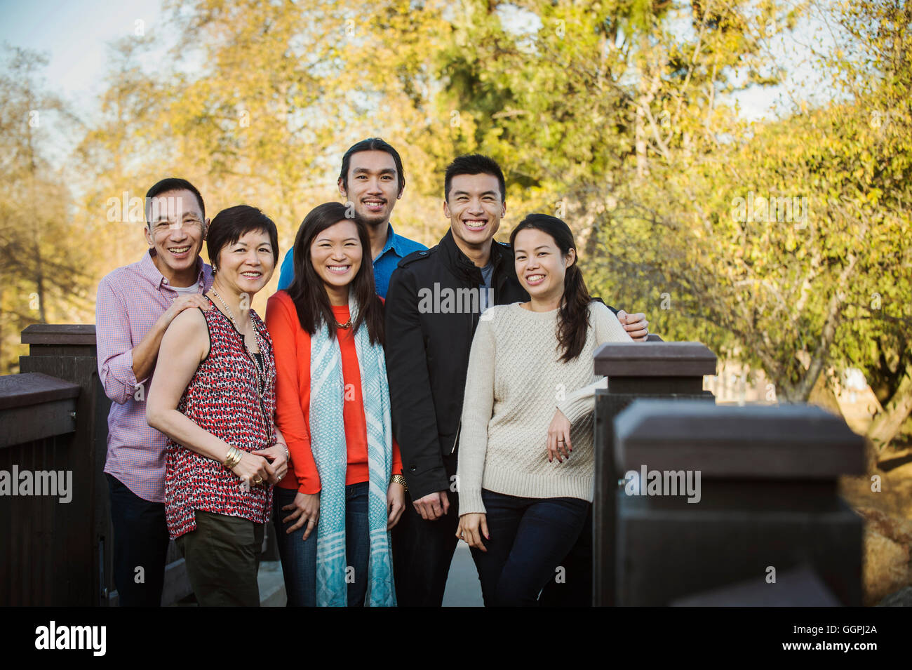 Chinese family smiling outdoors Stock Photo