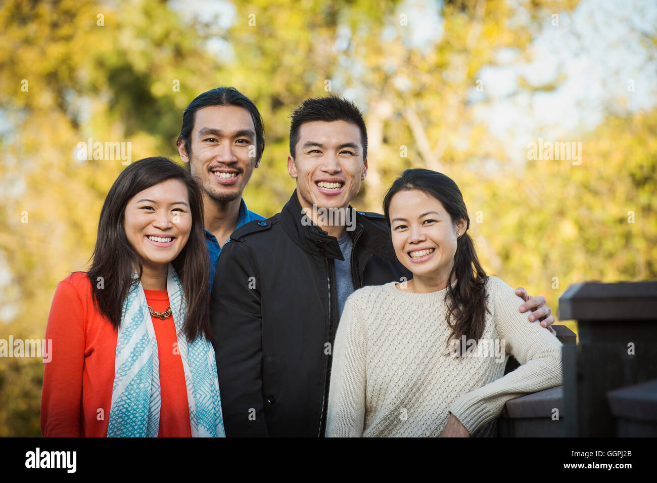 Adult Chinese siblings smiling outdoors Stock Photo