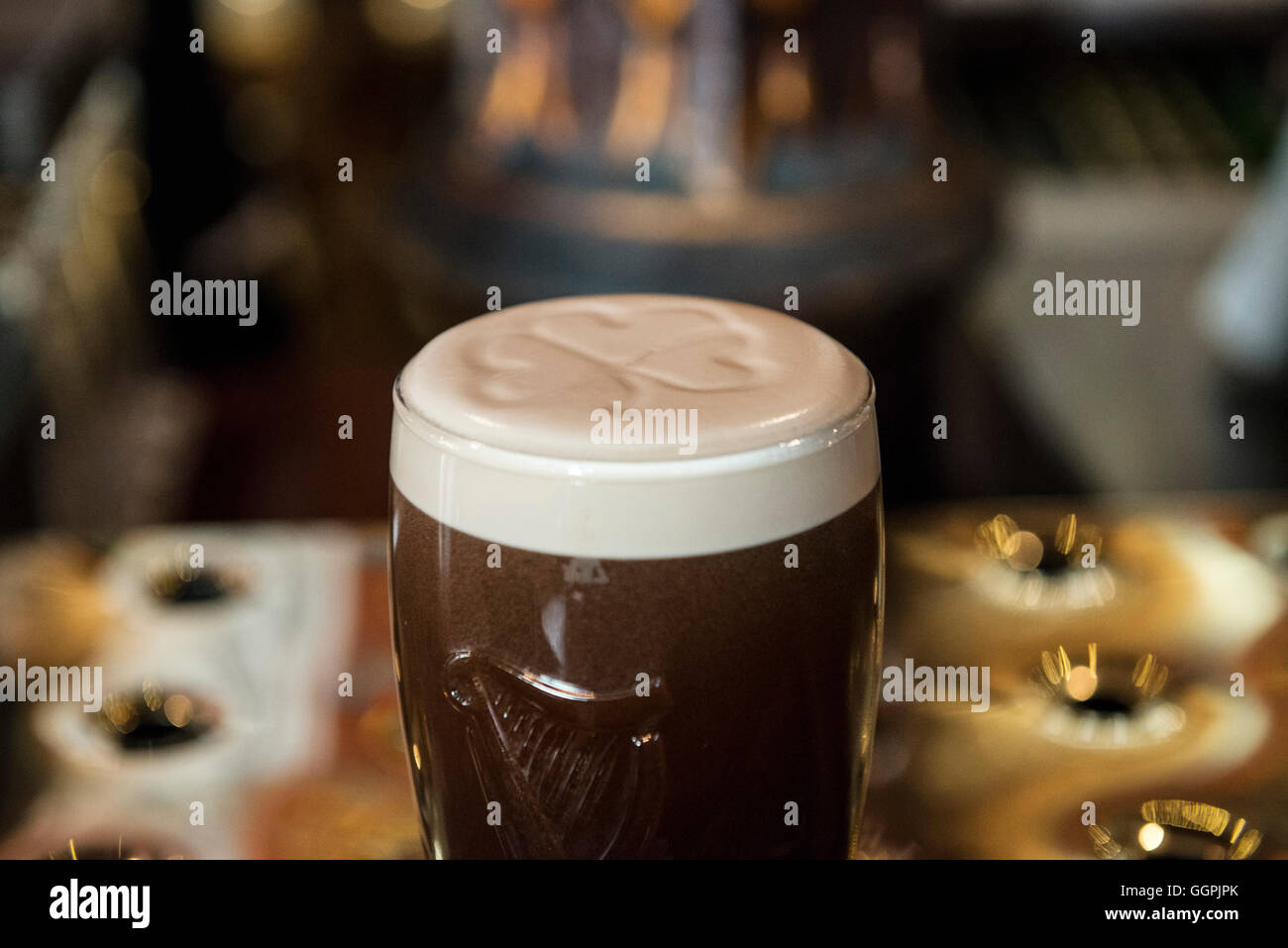 Guinness with shamrock in, Belfast Stock Photo