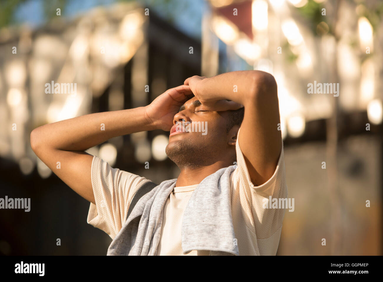 Mixed Race man with headache outdoors Stock Photo