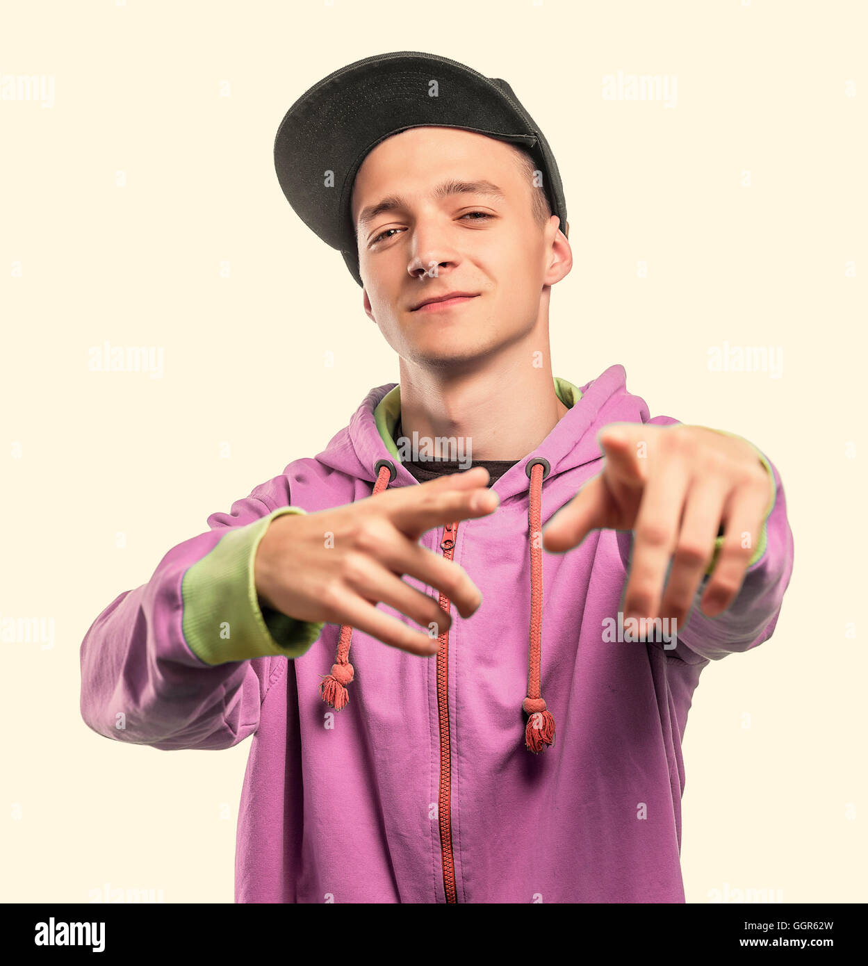 Party-goer in blue dress makes signs with his hands. On a white background. Toned photo. Stock Photo