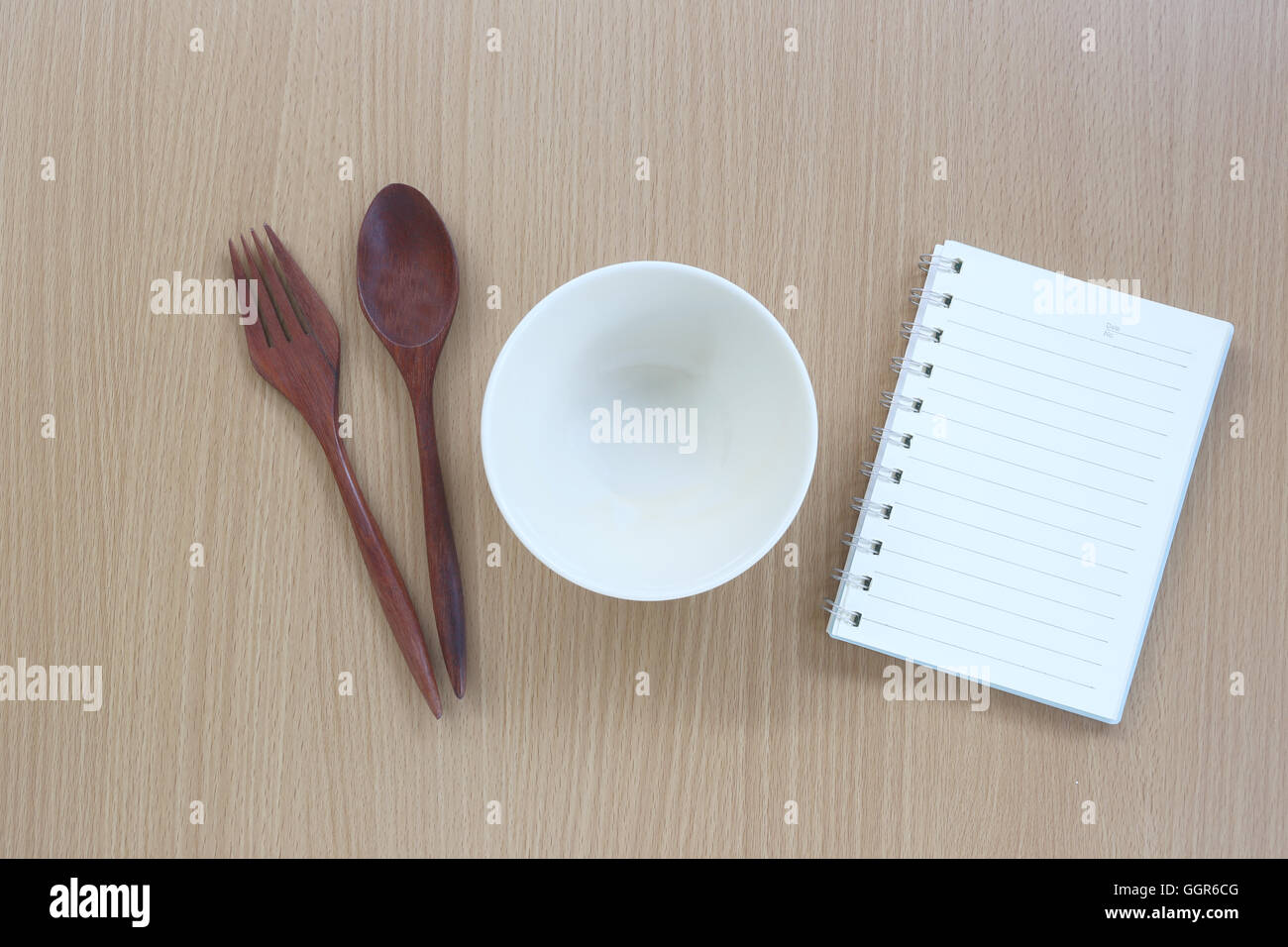 kitchen utensils and note book on wood background for design Concept in food. Stock Photo