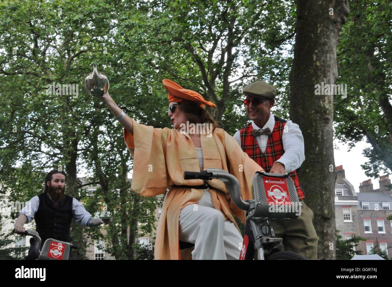 A competitor at the tea pouring while cycling event, at London's Chap Olympiad. Stock Photo