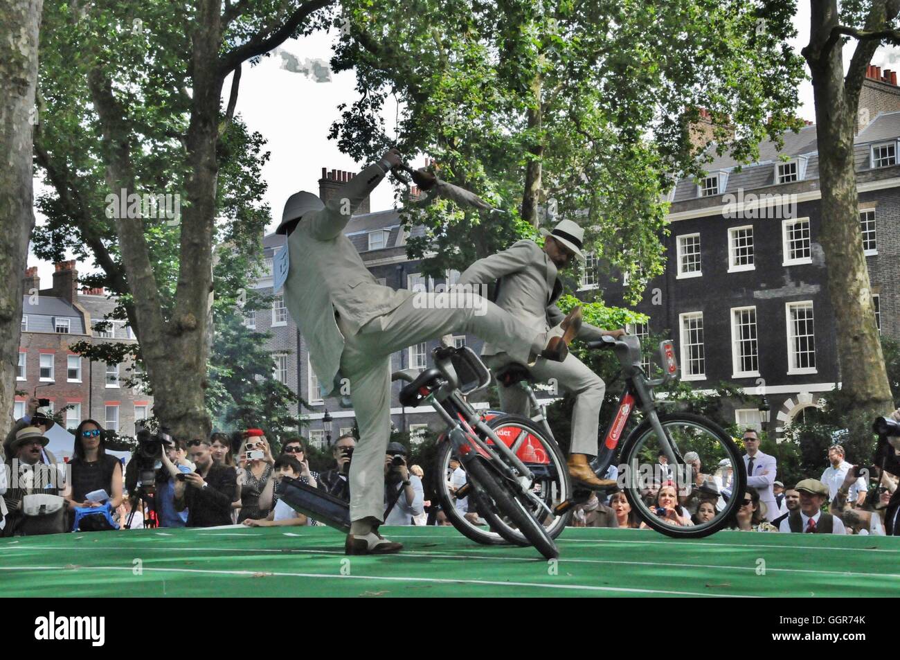 A competitor is knocked of his bicycle, at the Chap Olympiad bicycle joust. Stock Photo