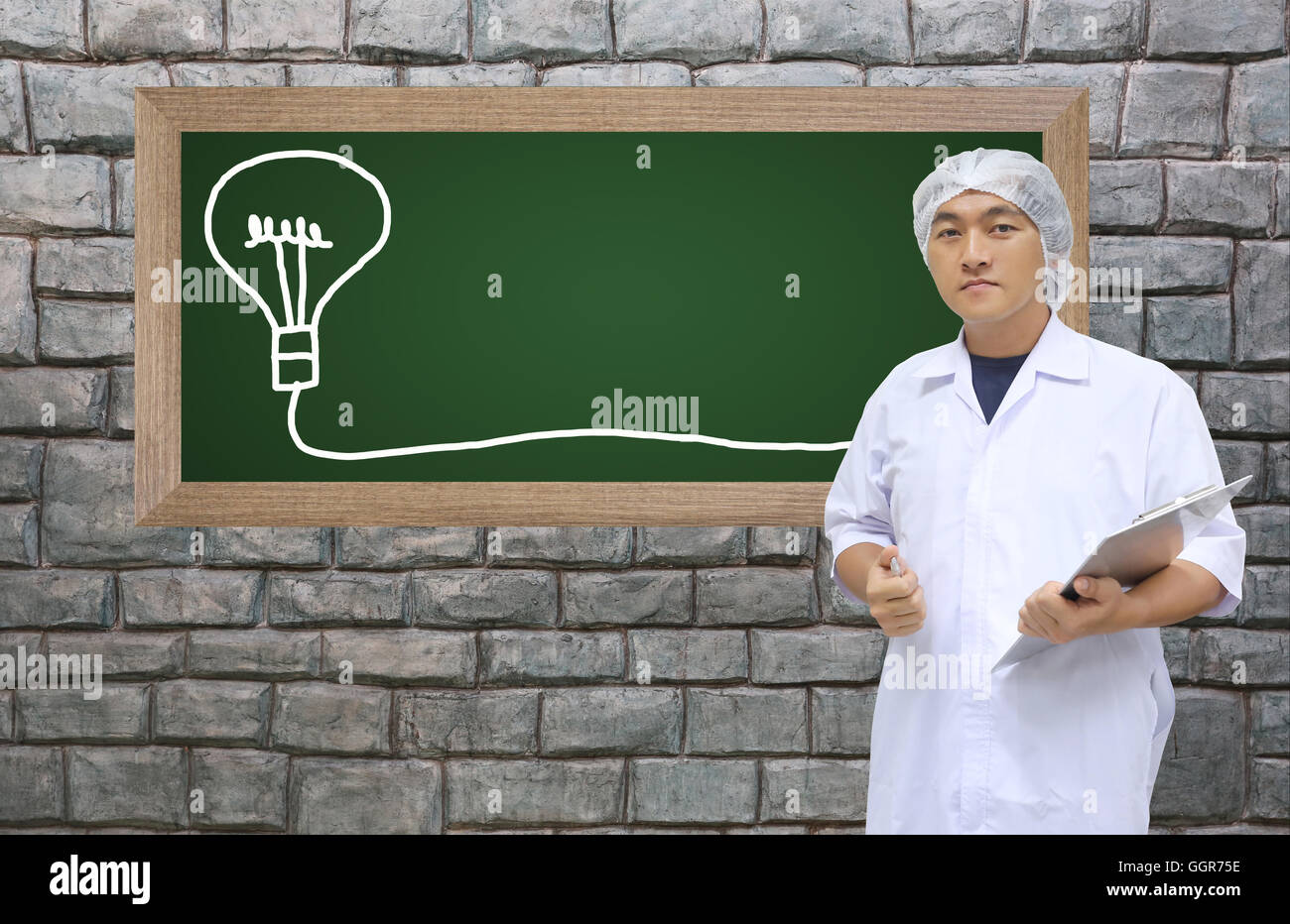 A man in white great coat uniform and black board with space to add text for Concept design Business. Stock Photo