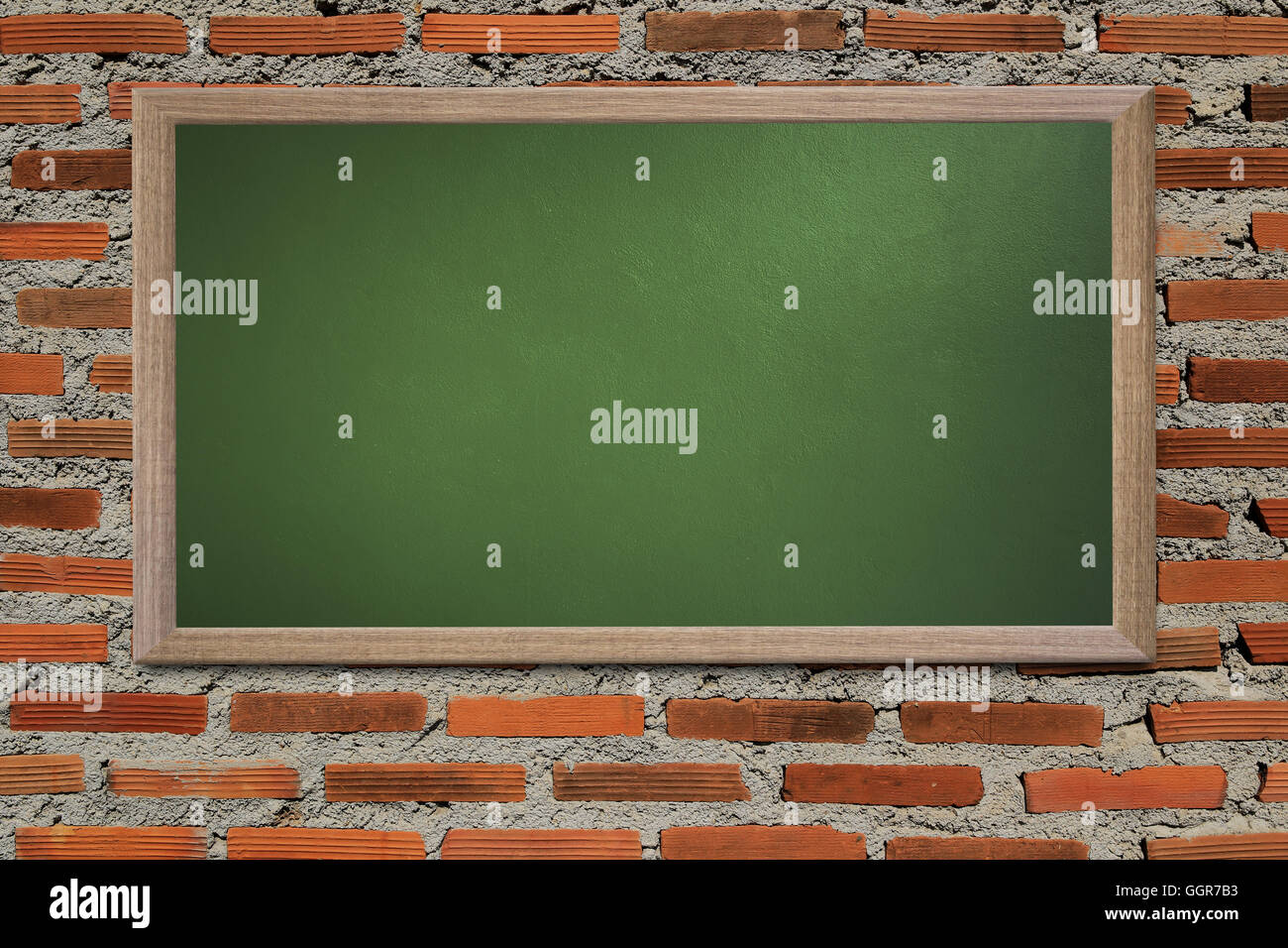 Blank old school blackboard on a grunge wall and can input text or data to wooden frame for concept of education. Stock Photo