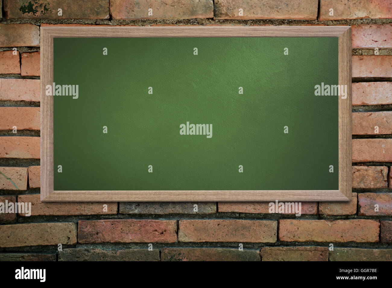 Blank old school blackboard on a grunge wall and can input text or data to wooden frame for concept of education. Stock Photo