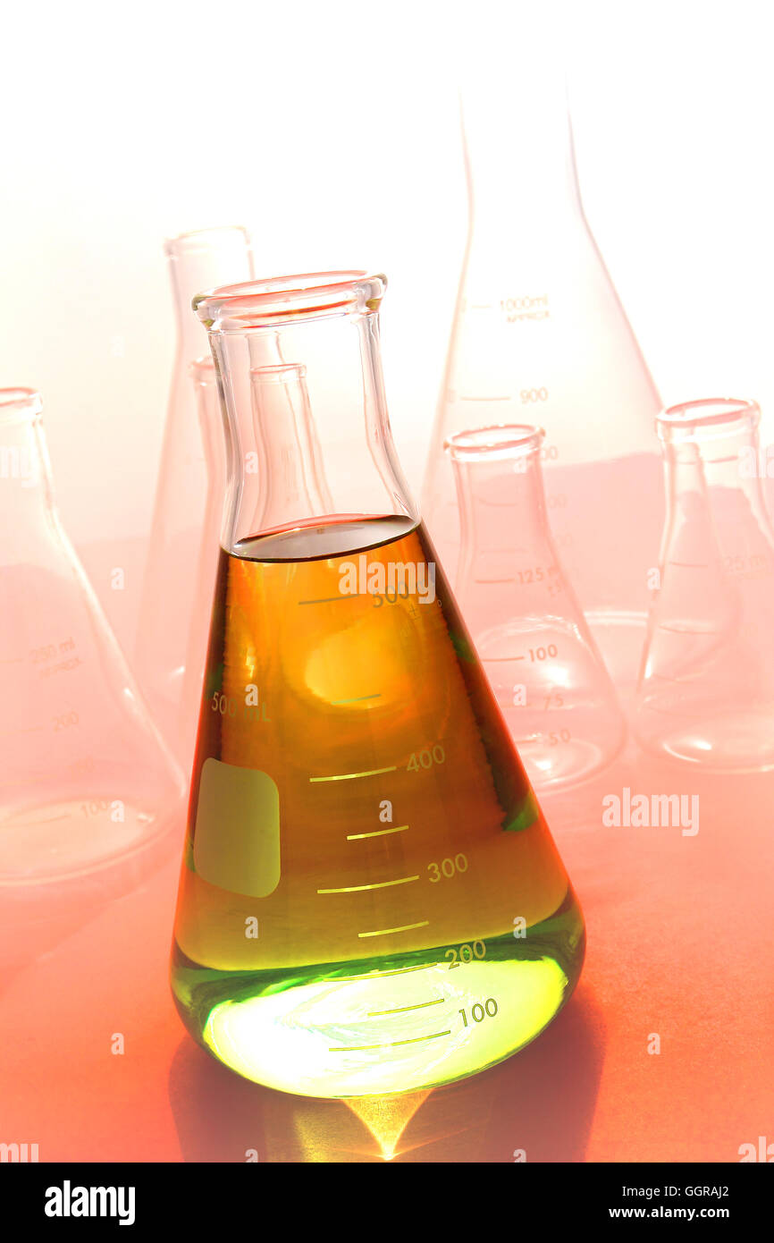 Scientific laboratory glass conical Erlenmeyer flask filled with amber