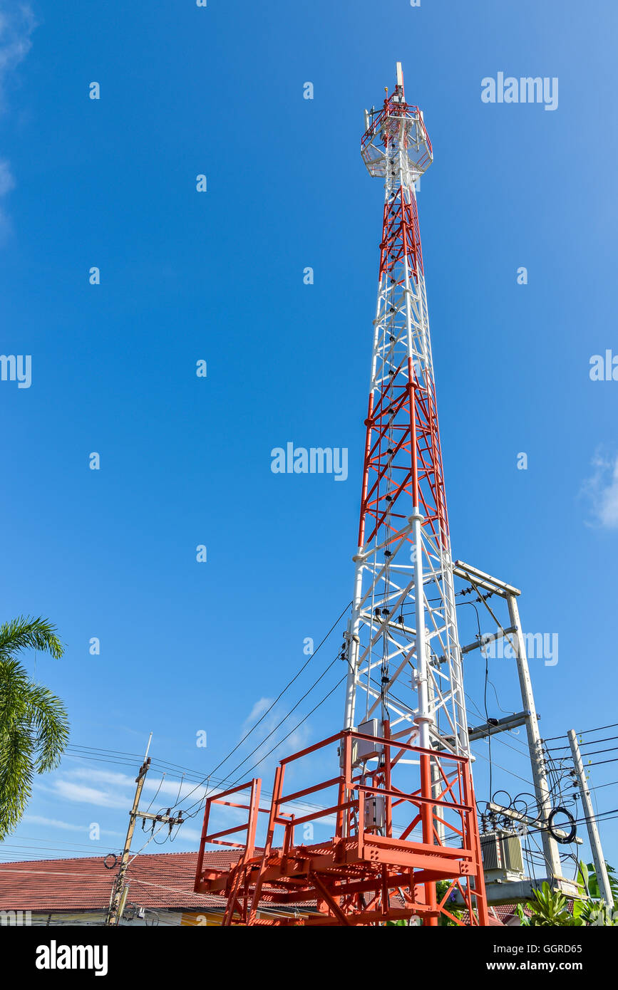 Mobile phone base station tower in blue sky. Stock Photo