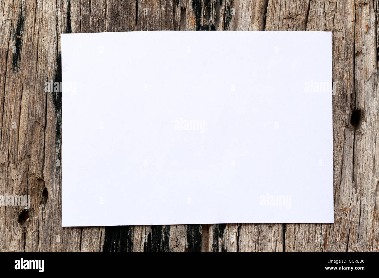 white paper of rectangle on brown wood background and copy space to input text. Stock Photo