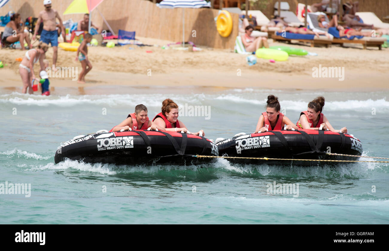Speedboat Fun inflatable ride pulled along by speedboat beach fun Stock Photo - Alamy