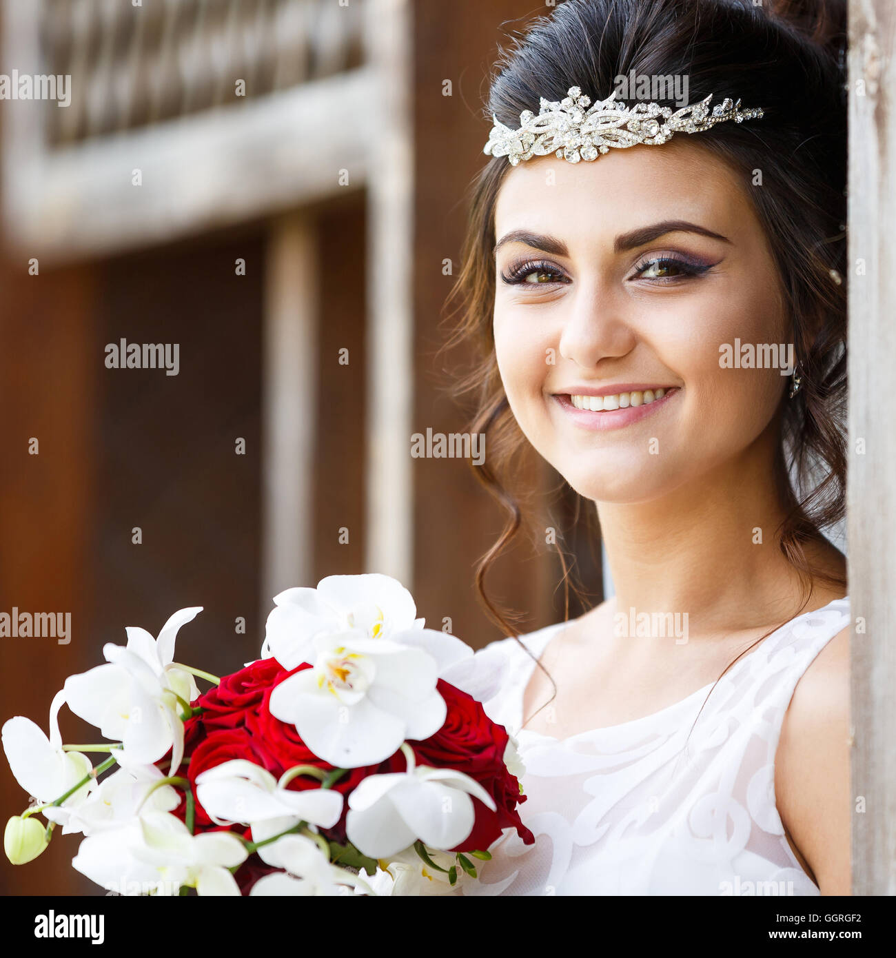 Beautiful bride with bouquet against the wooden background Stock Photo