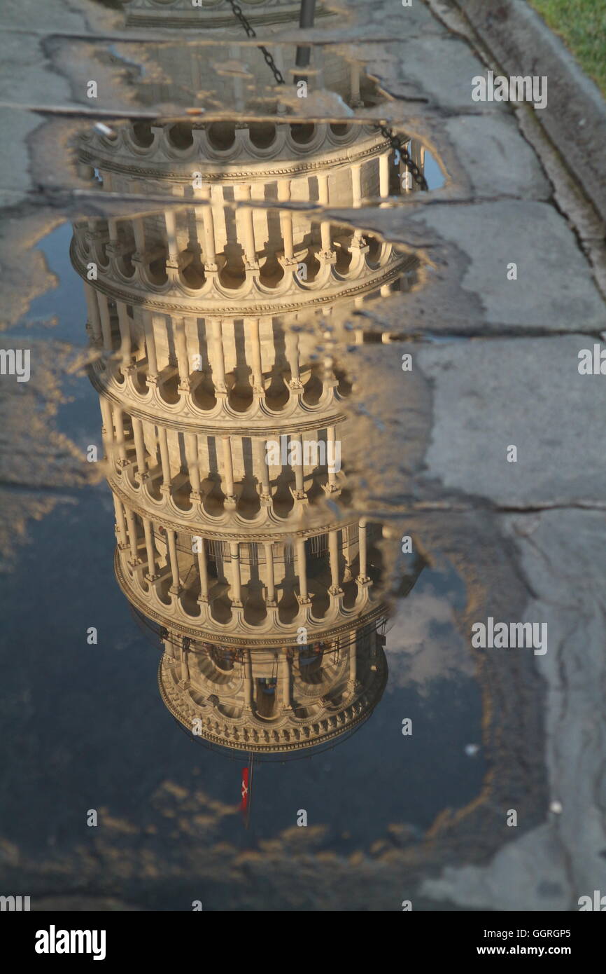 Reflection of leaning tower of pisa in puddle Stock Photo