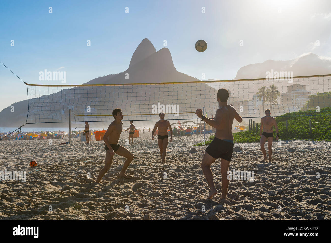 RIO DE JANEIRO - MARCH 27, 2016: Young carioca Brazilians play futevôlei (footvolley, combining football/soccer and volleyball). Stock Photo