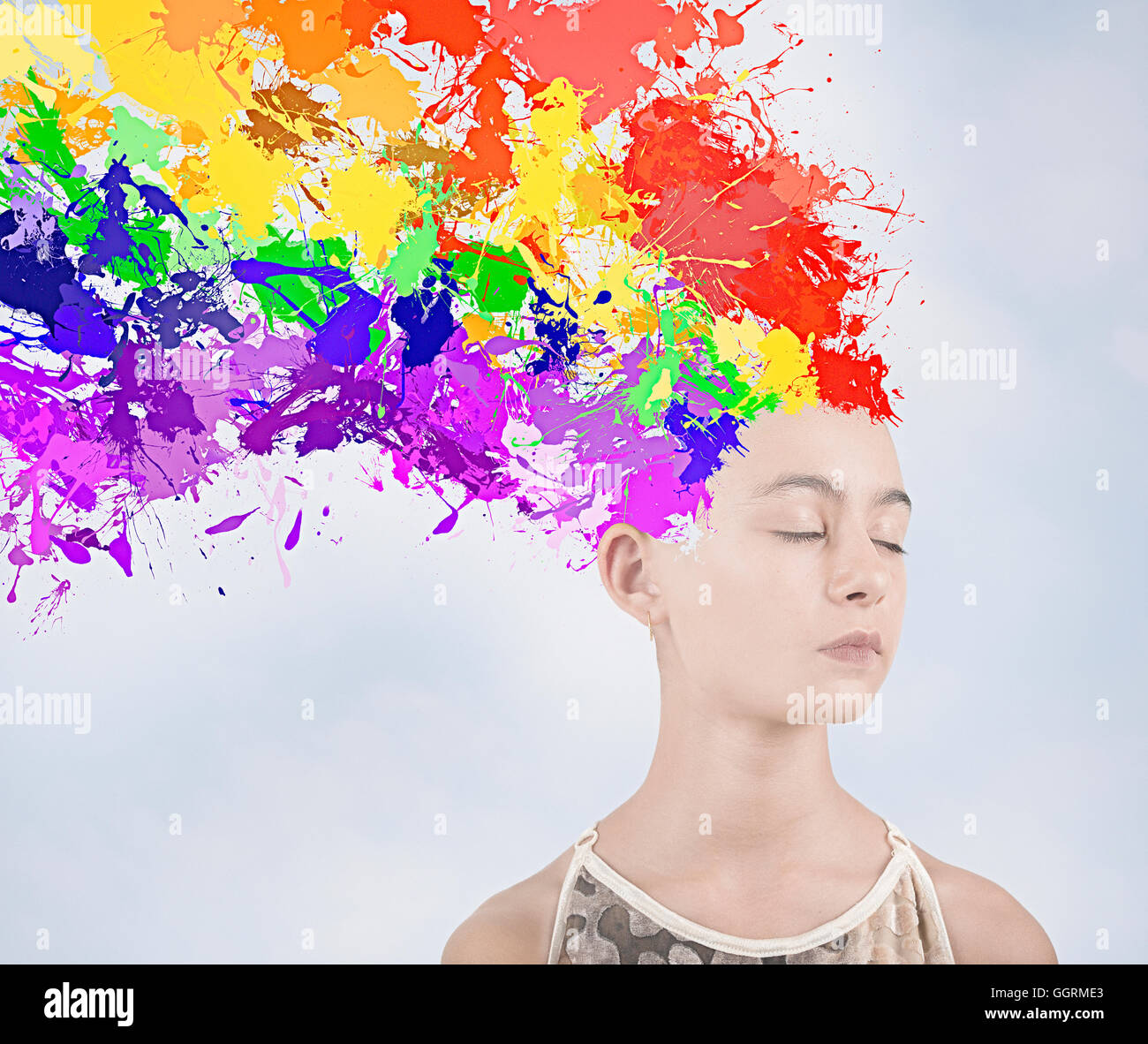 Paint splatter exploding from head of Mixed Race girl Stock Photo