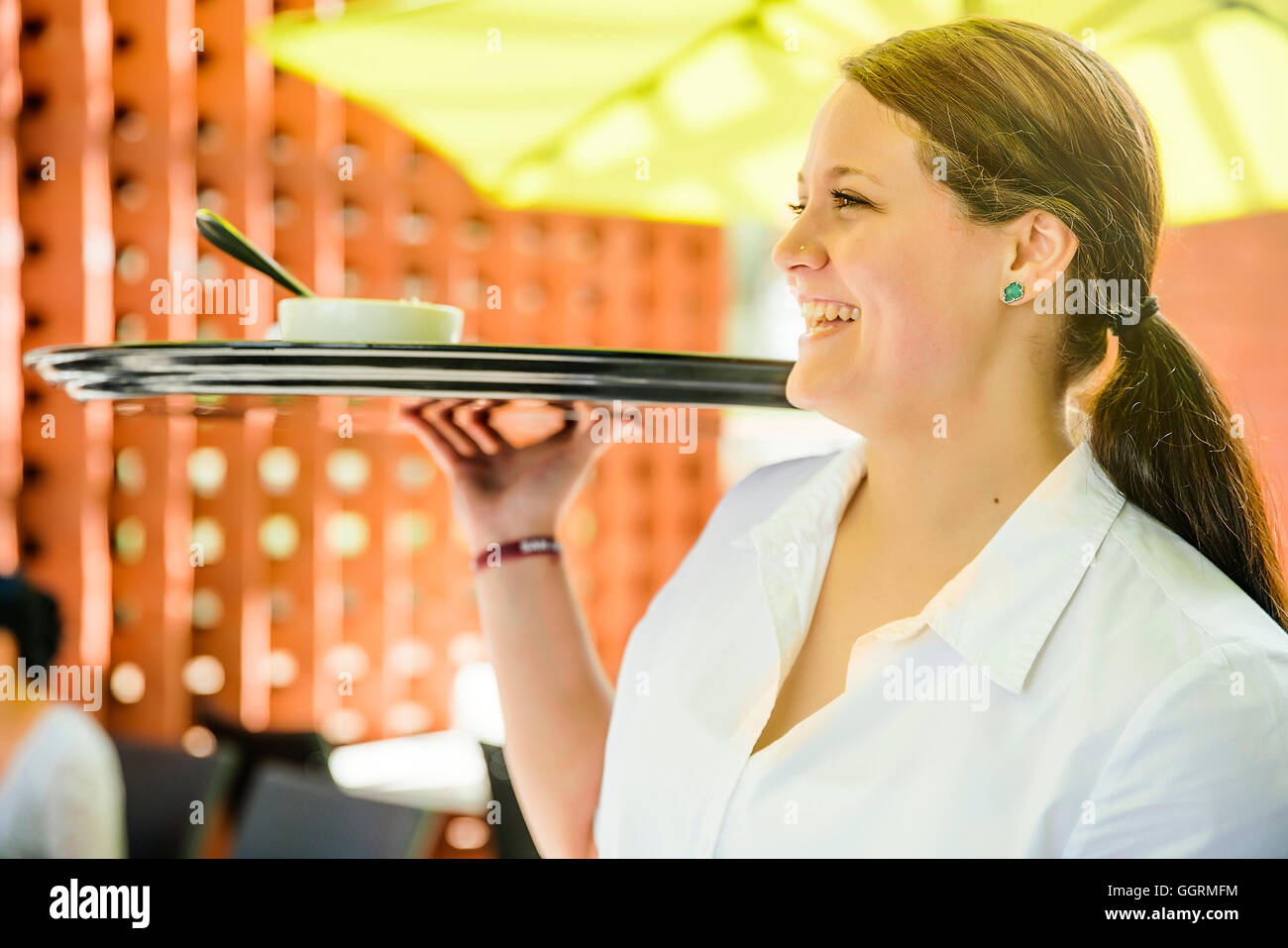 Caucasian waitress carrying tray in restaurant Stock Photo Alamy