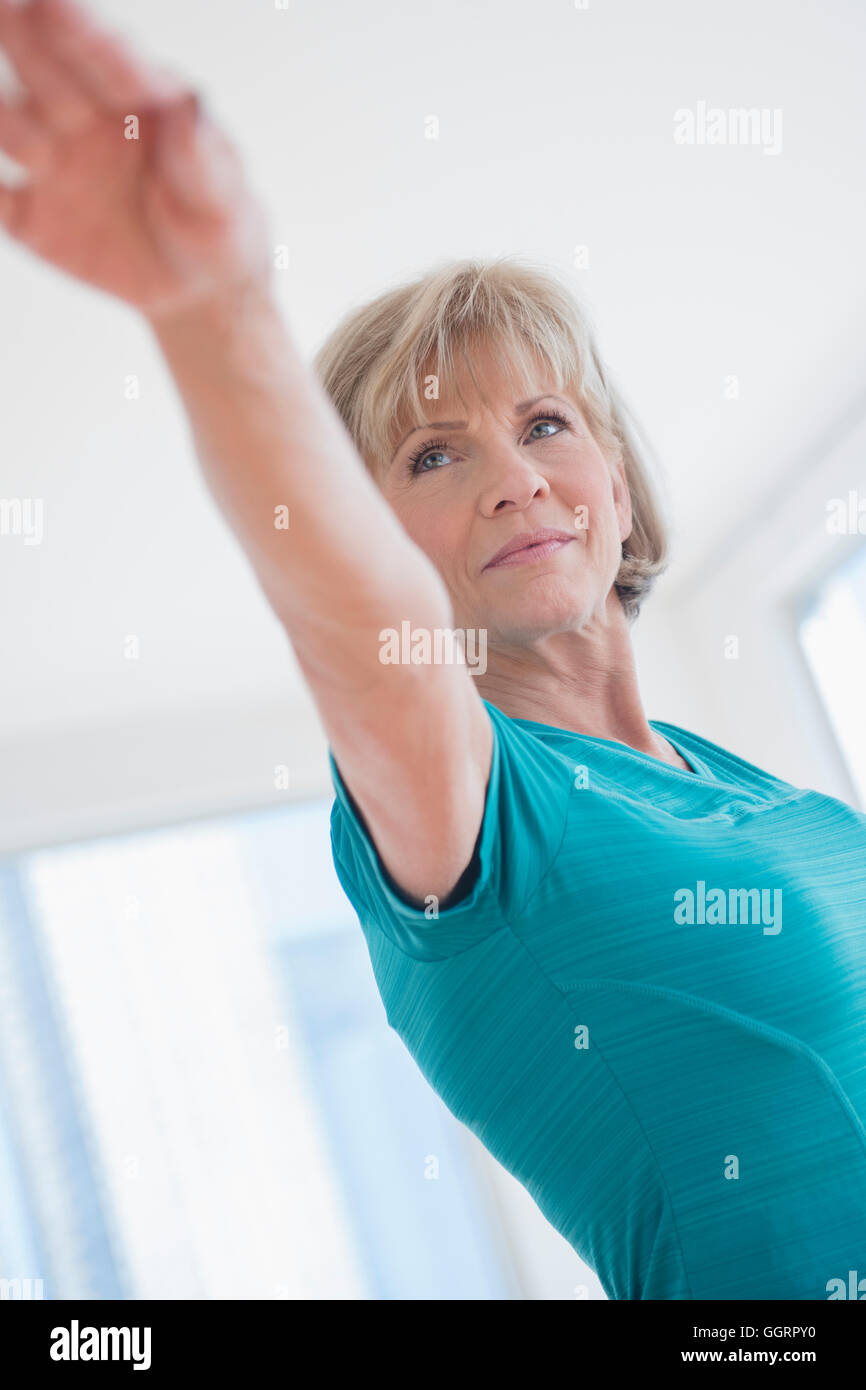 Older Caucasian woman with arms outstretched Stock Photo