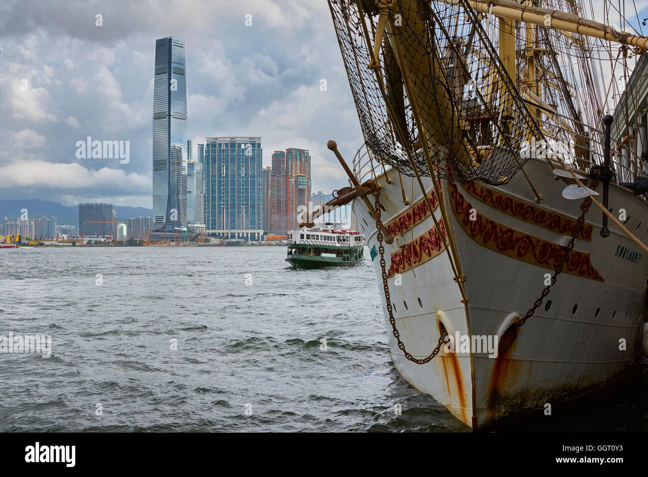 The Norwegian Tall Ship, Sørlandet, Moored At The Central Ferry Pier, The Kowloon Skyline In Background, Hong Kong. Stock Photo