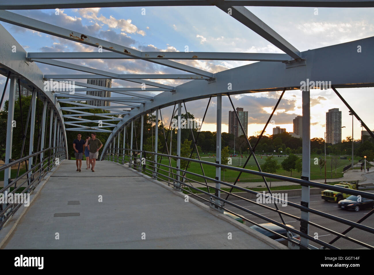 Two young men walk over the pedestrian bridge over Lake Shore Drive leading from Lincoln Park to the North Avenue Beach. Stock Photo