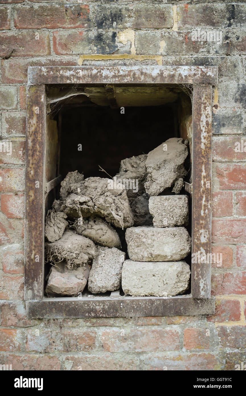 Rubble in a window in a building at Seagram's Farm in Imber village on Salisbury Plain, Wiltshire, where residents were evicted in 1943 to provide an exercise area for US troops preparing to invade Europe. Roads through the MoD controlled village are now open and will close again on Monday August 22. Stock Photo