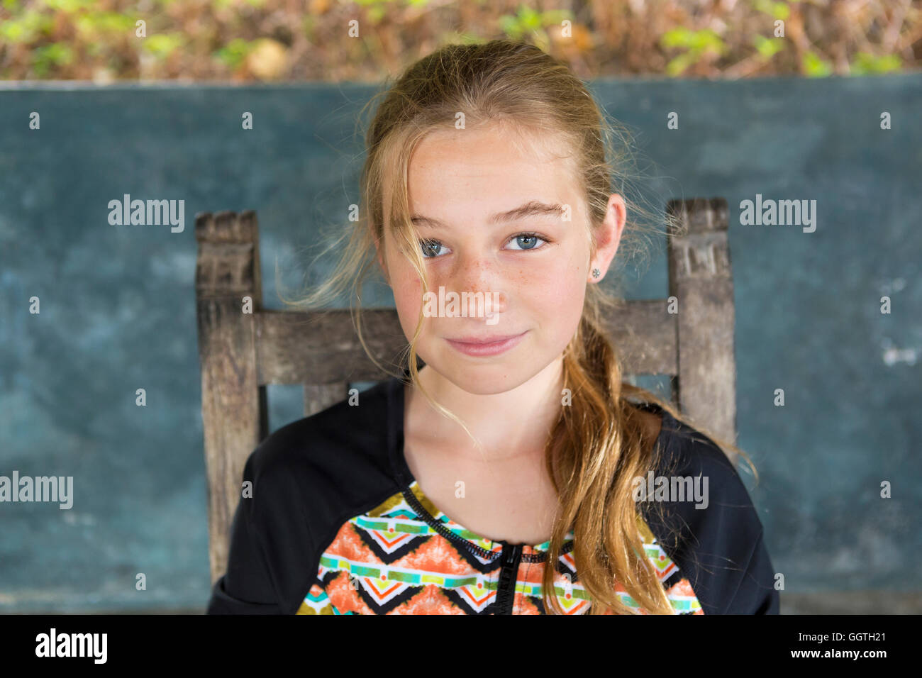 Caucasian girl sitting in chair Stock Photo - Alamy