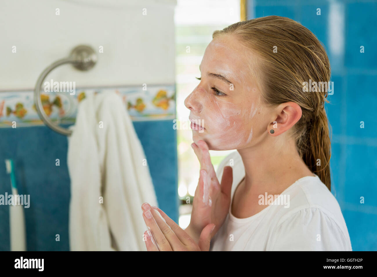 Caucasian girl washing face with soap Stock Photo
