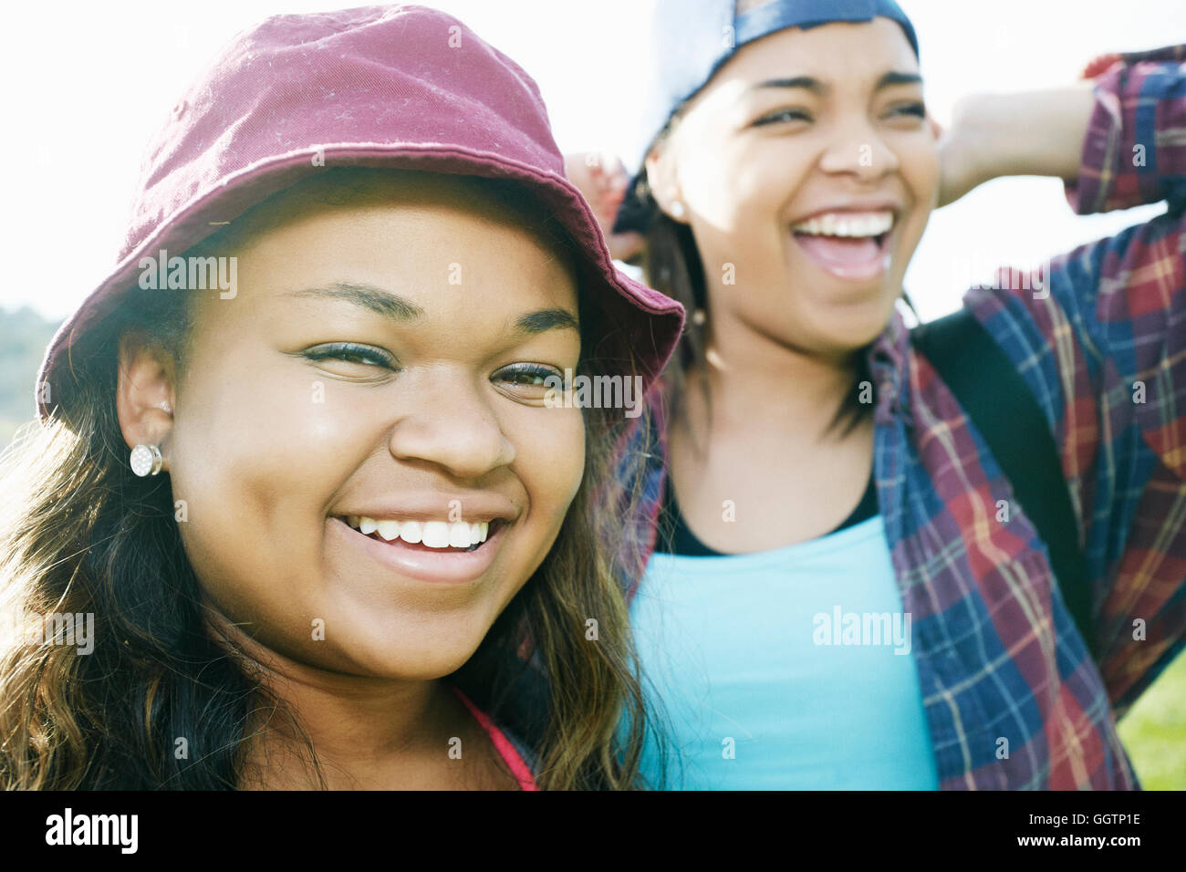 Mixed Race sisters laughing outdoors Stock Photo