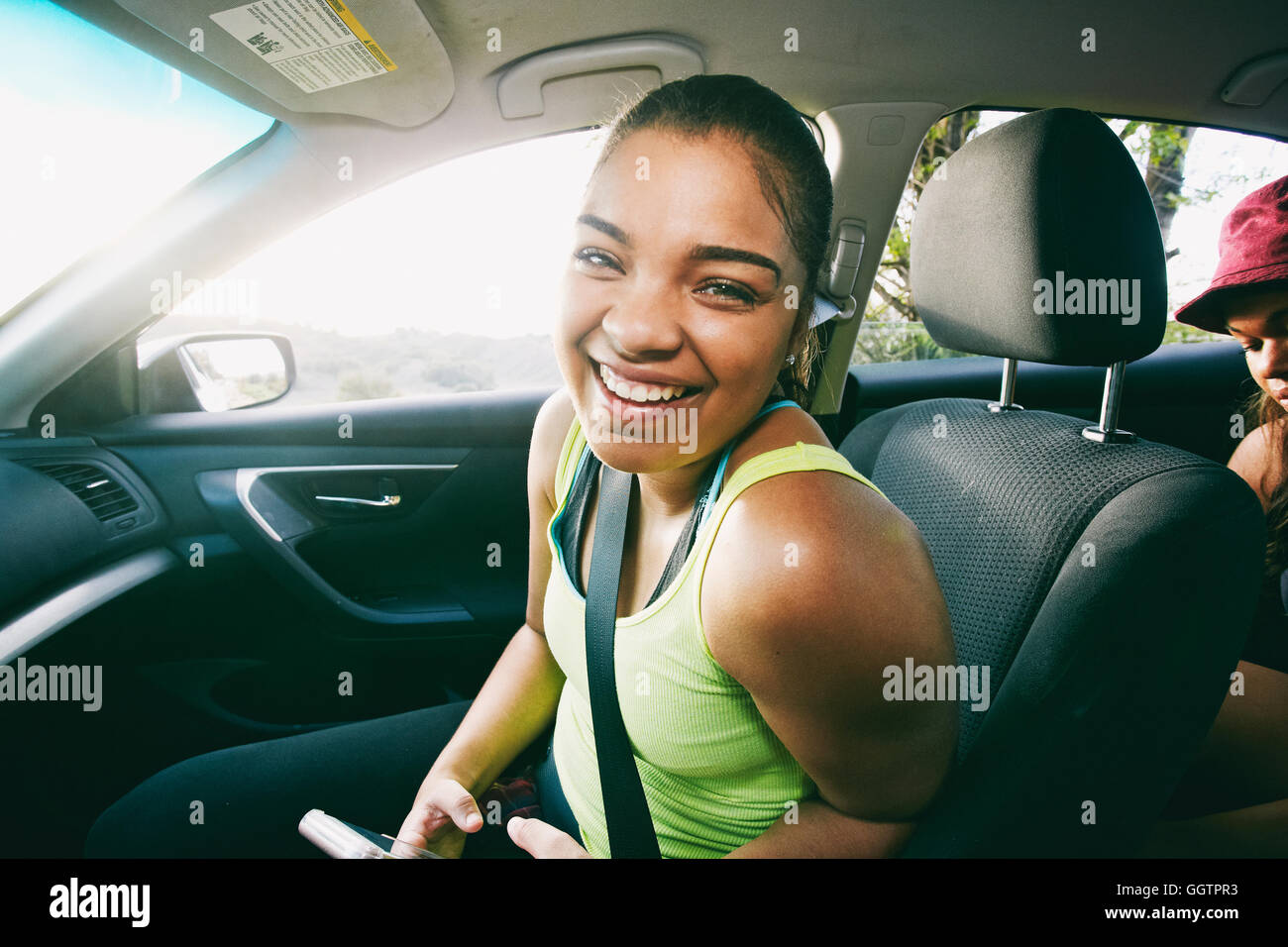 Mixed Race woman laughing in car Stock Photo