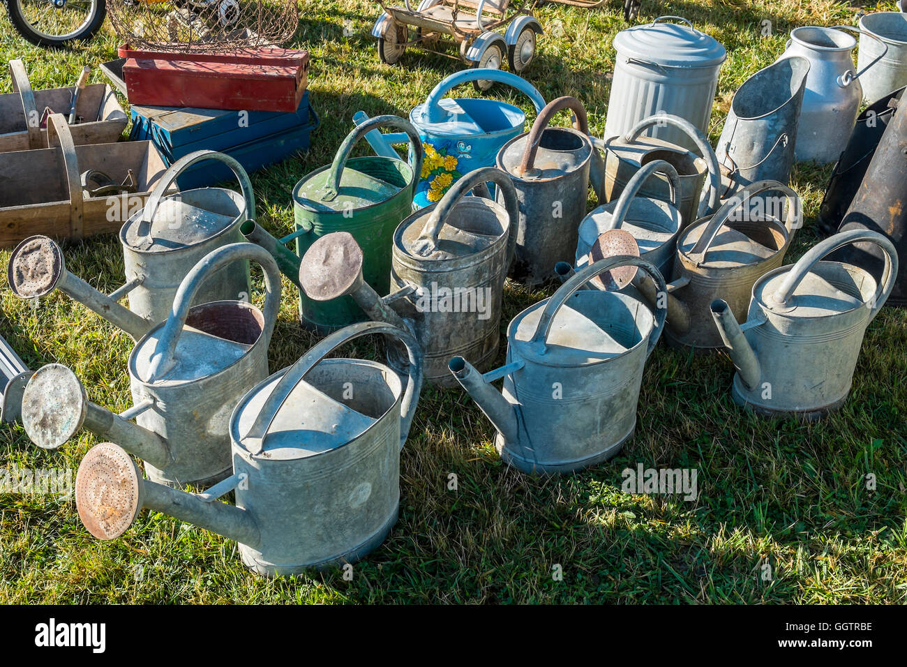 Display of old watering cans and utensils at open-air event - sud-Touraine, France. Stock Photo