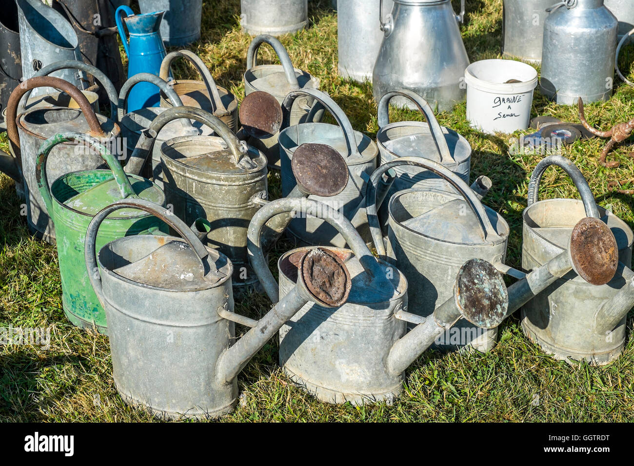 Display of old watering cans and utensils at open-air event - sud-Touraine, France. Stock Photo