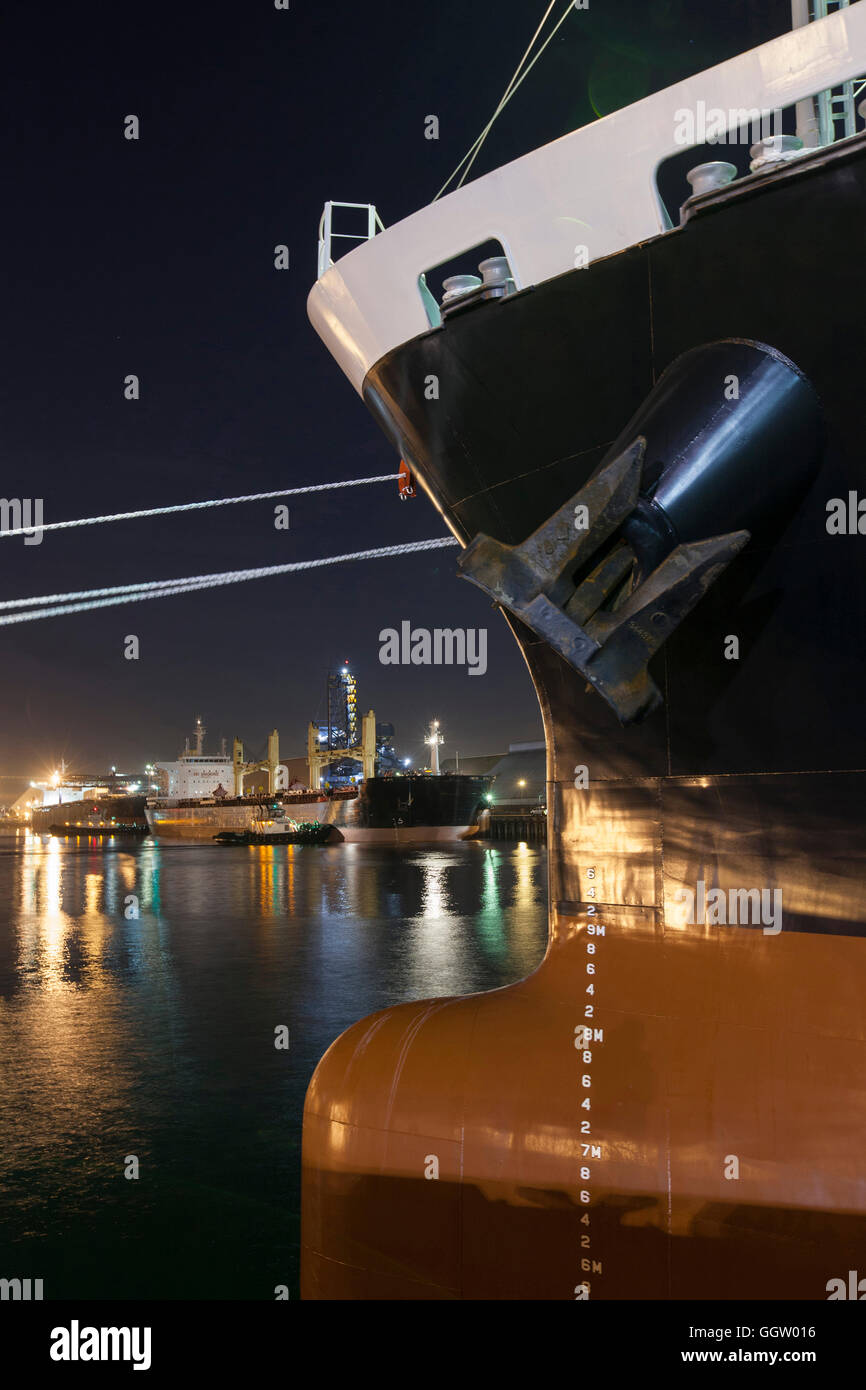 Ships moored at commercial dock at night Stock Photo