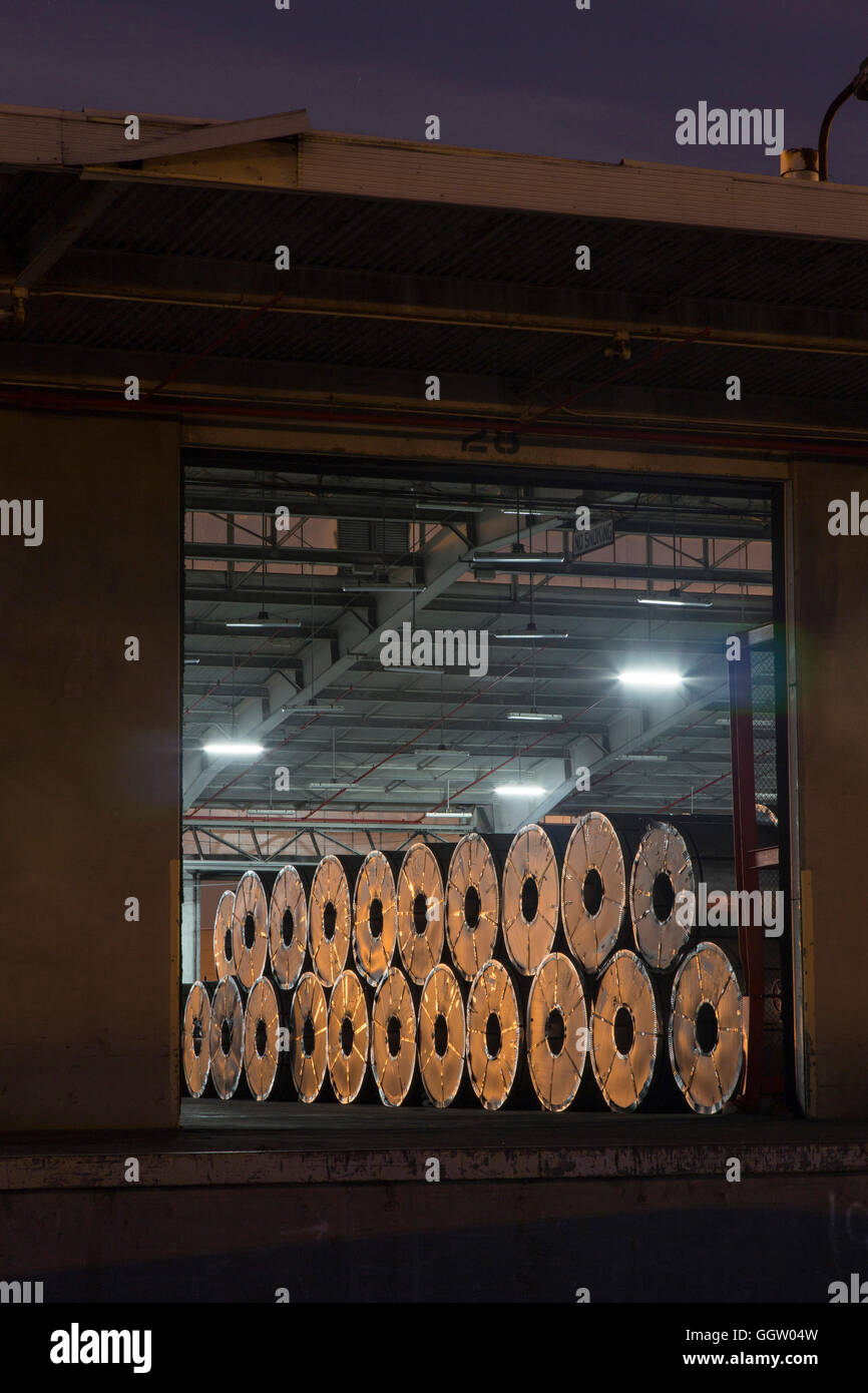 Metal rolls on warehouse loading dock Stock Photo