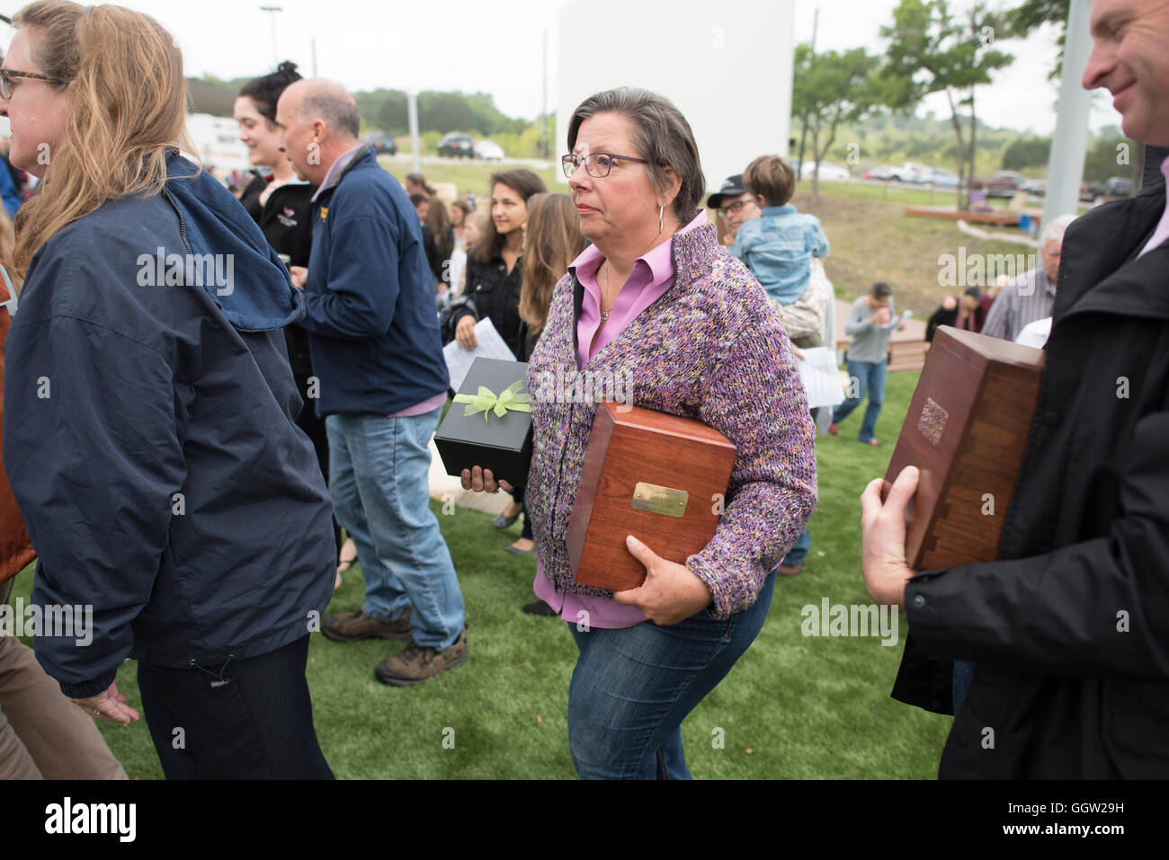 Woman carrying the ashes of a family member at interment ceremony at Community First! Village in Austin, Texas Stock Photo