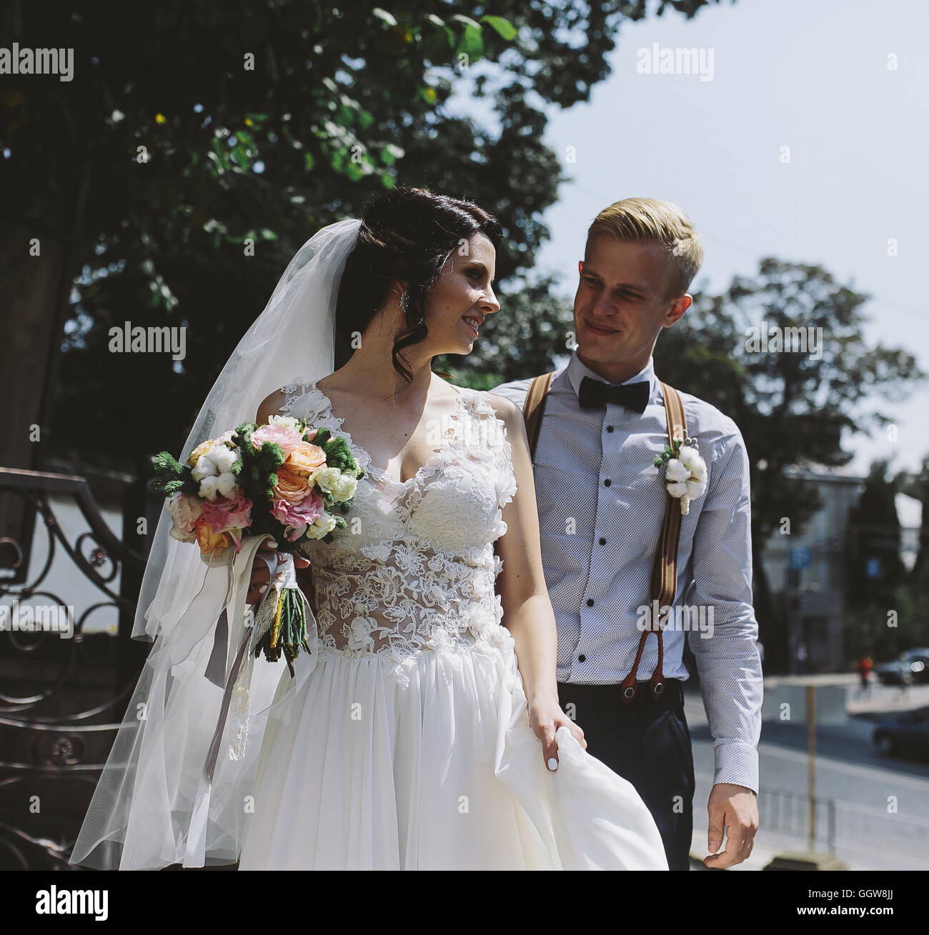 bride and groom posing on the streets Stock Photo - Alamy