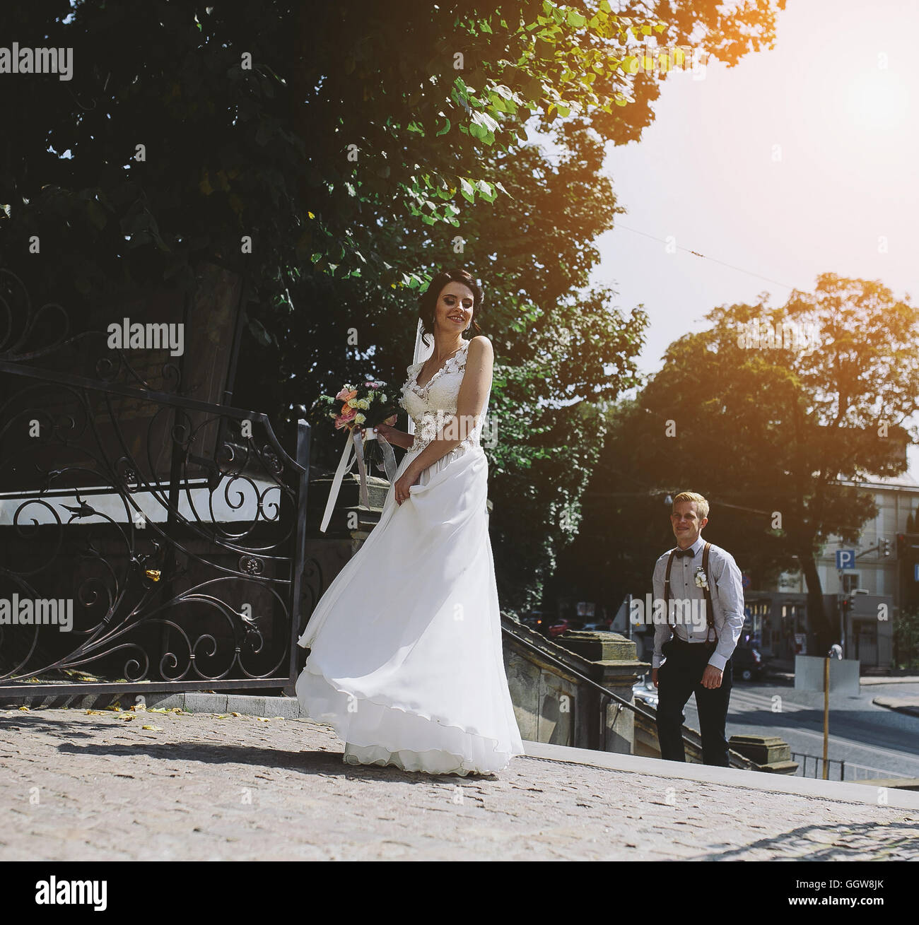 bride and groom posing on the streets Stock Photo - Alamy