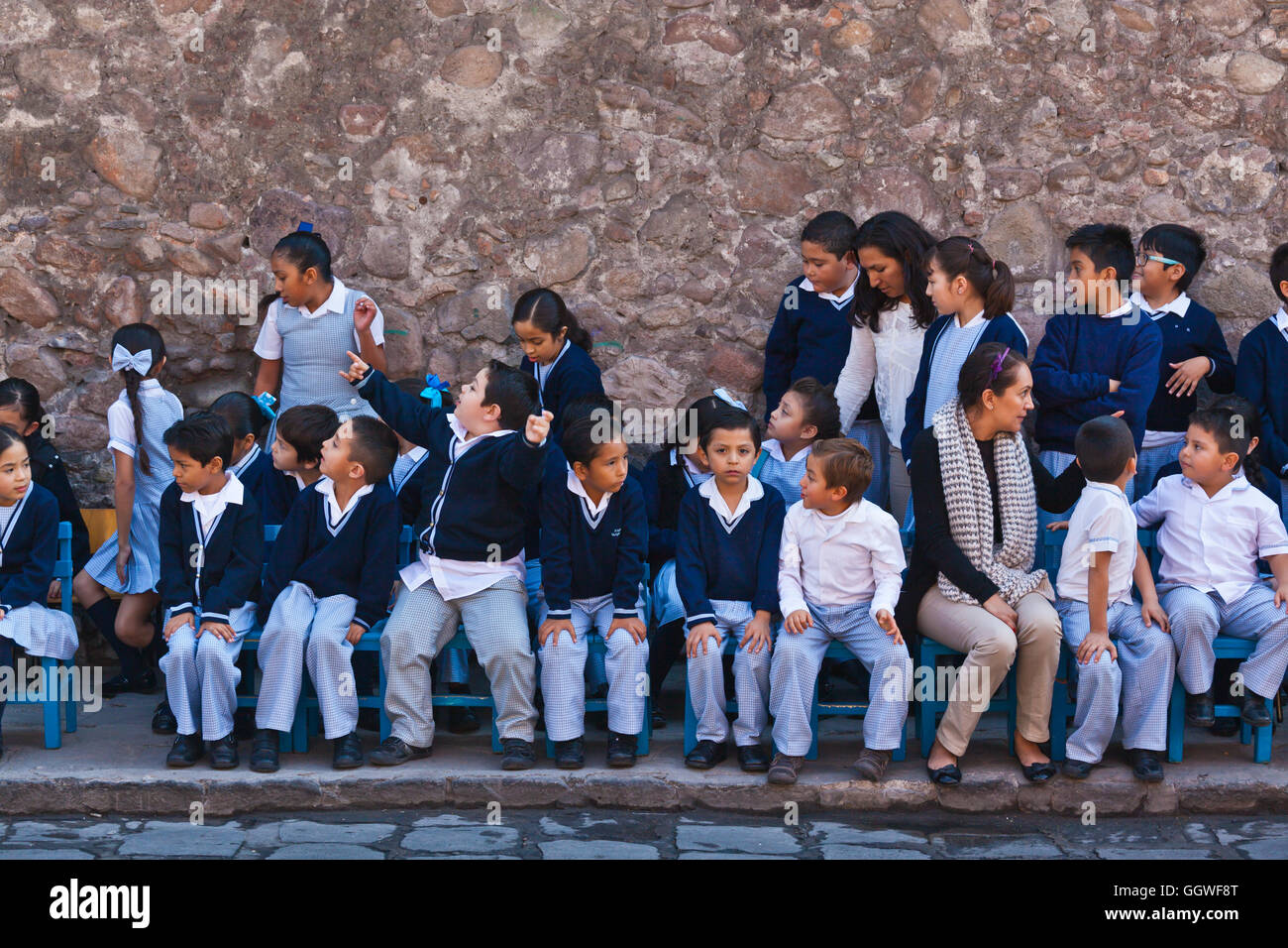 School children watch the parade celebrating DAY OF THE REVOLUTION on