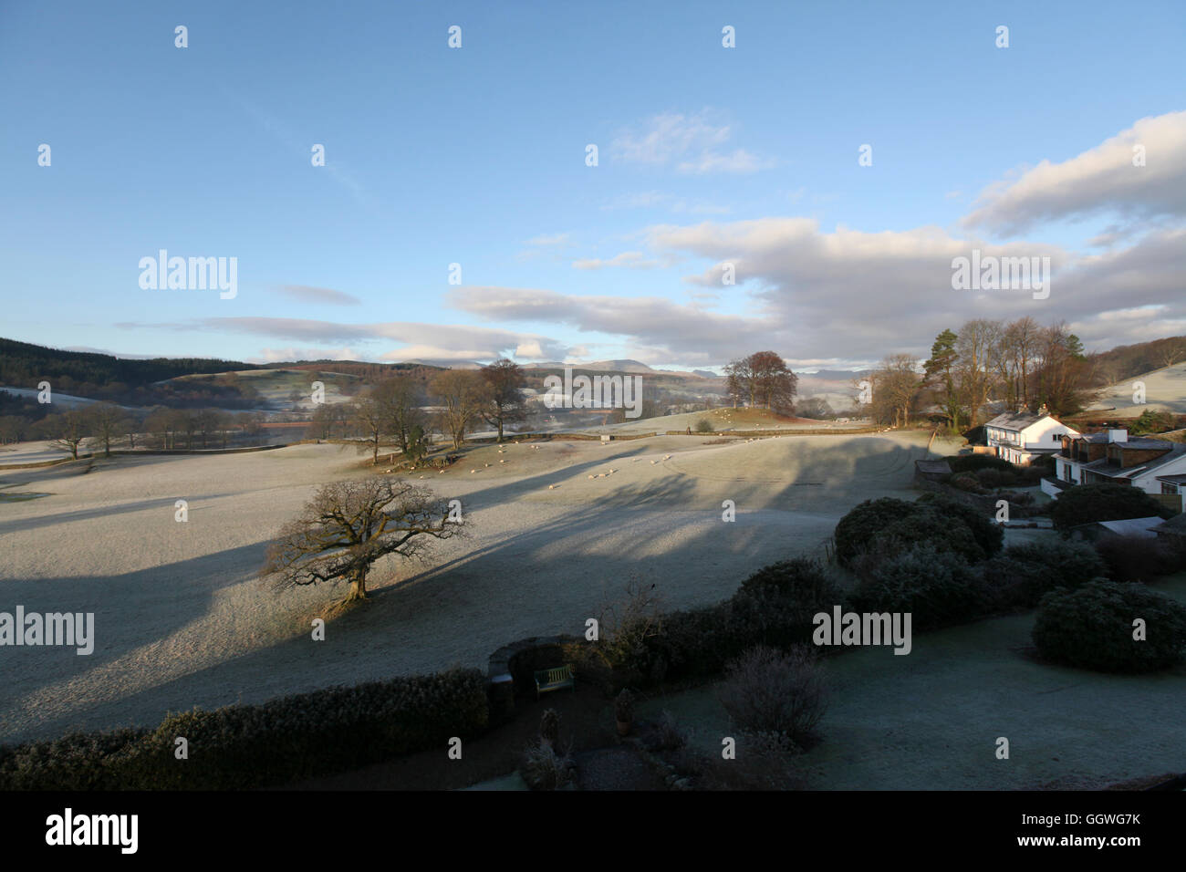 An sunny, frosty, early morning view over fields and woodland to Esthwaite Water Stock Photo