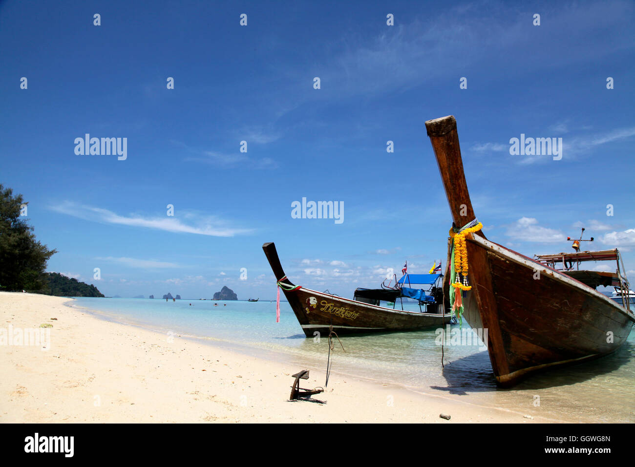 Two Thai fishing boats pulled onto the beach of a Thai Island in the Andaman sea Stock Photo