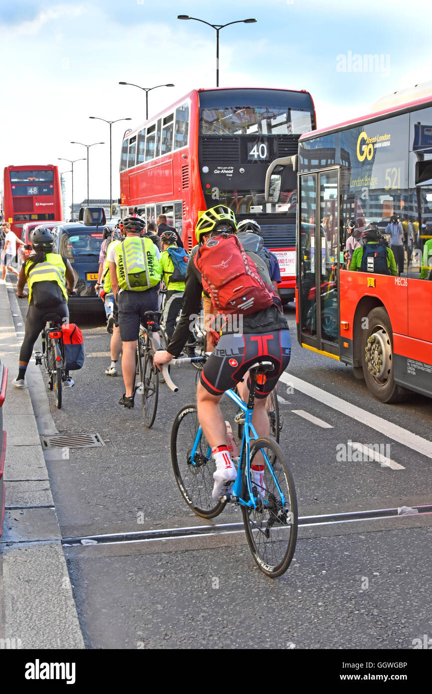 Rush hour on UK London Bridge as workers try to cycle home competing with other commuters & traffic in the scramble to get away from City of London Stock Photo