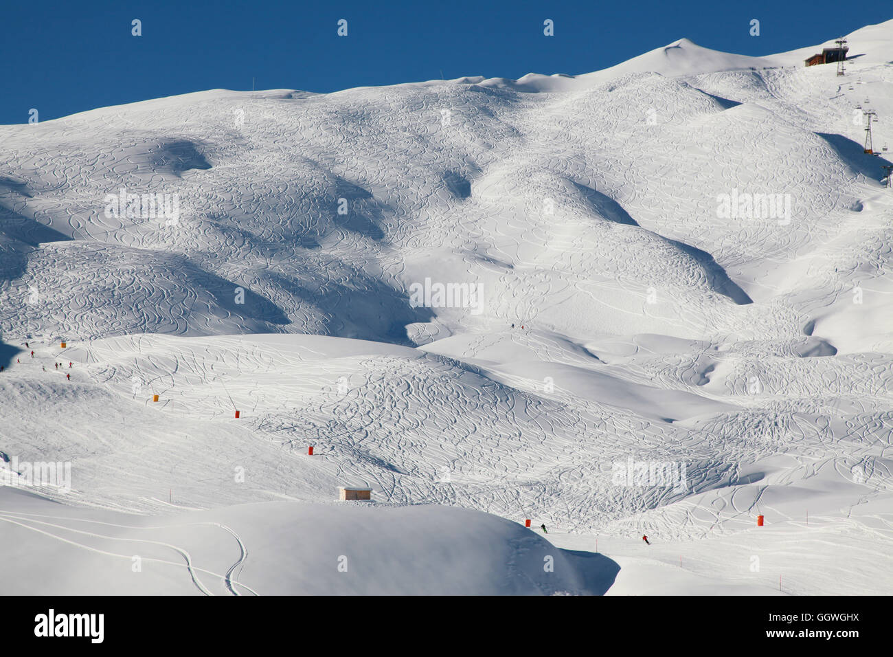 A criss cross of ski tracks gives these slopes a strange appearance Stock Photo