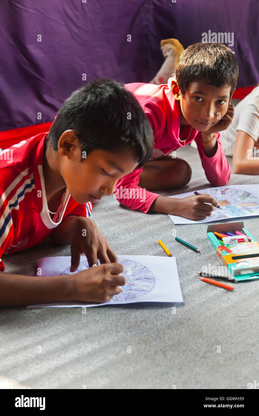 Children draw as part of a psychotherapy program in a remote village was put on by the and Development Society Nepal HDSN and fu Stock Photo