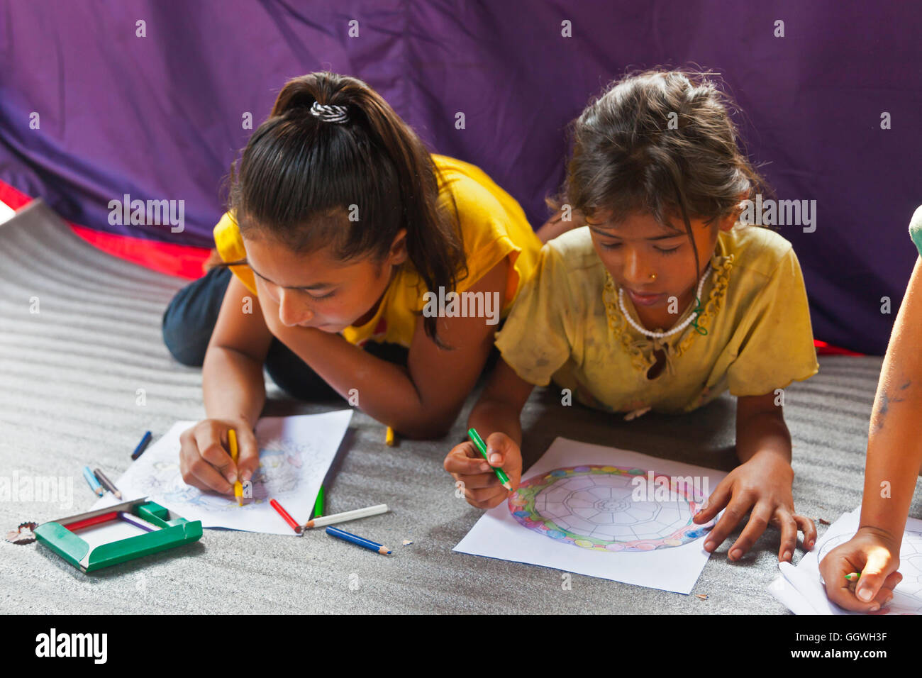 Children draw as part of a psychotherapy program in a remote village was put on by the and Development Society Nepal HDSN Stock Photo