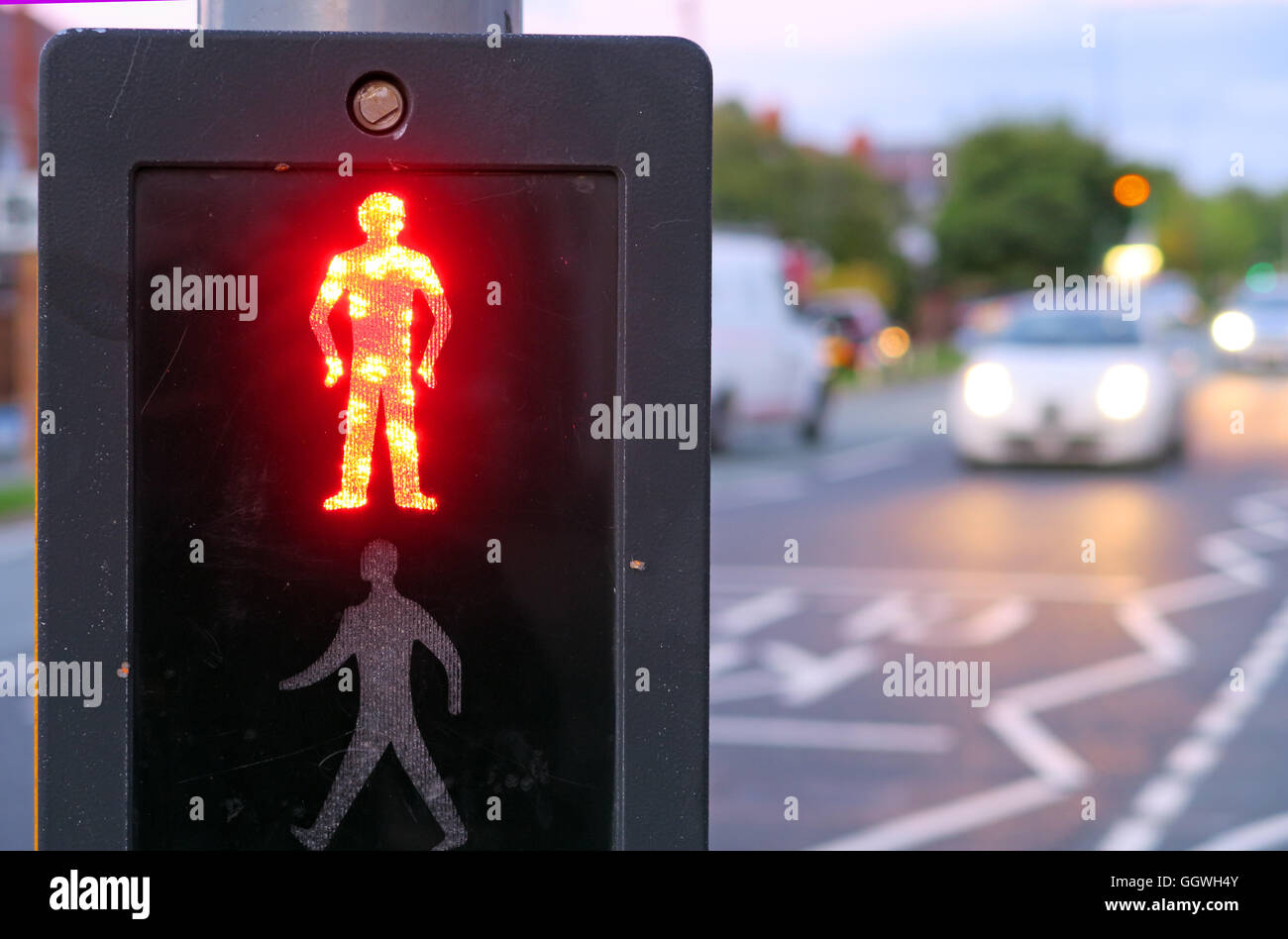 Red man at UK Pelican Crossing, with evening traffic in background Stock Photo