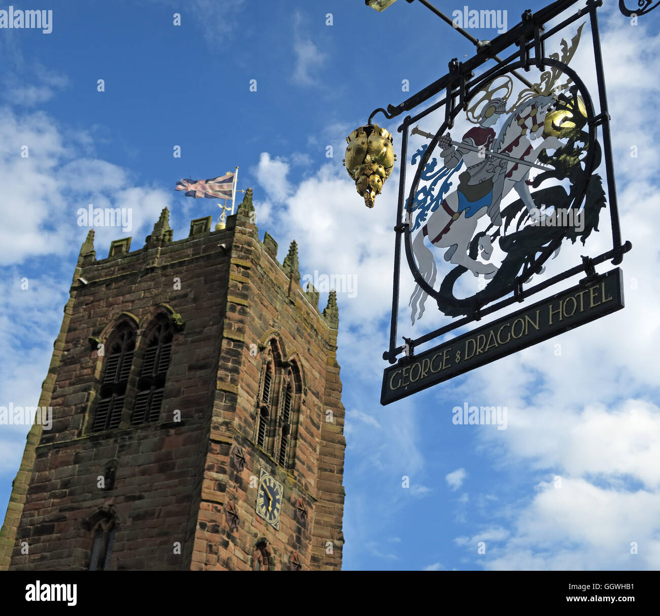 George and Dragon wrought iron sign and St Marys Church,Great Budworth,Cheshire,England, UK Stock Photo
