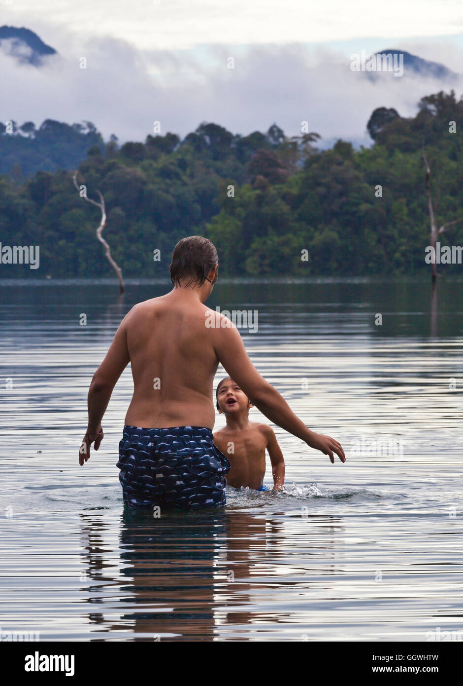 BODHI GARRETT with son BOON at the lake in KHAO SOK NATIONAL PARK - THAILAND Stock Photo
