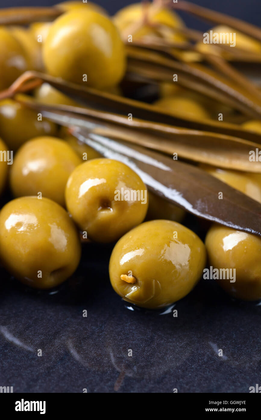 canned green olives on a black background Stock Photo Alamy