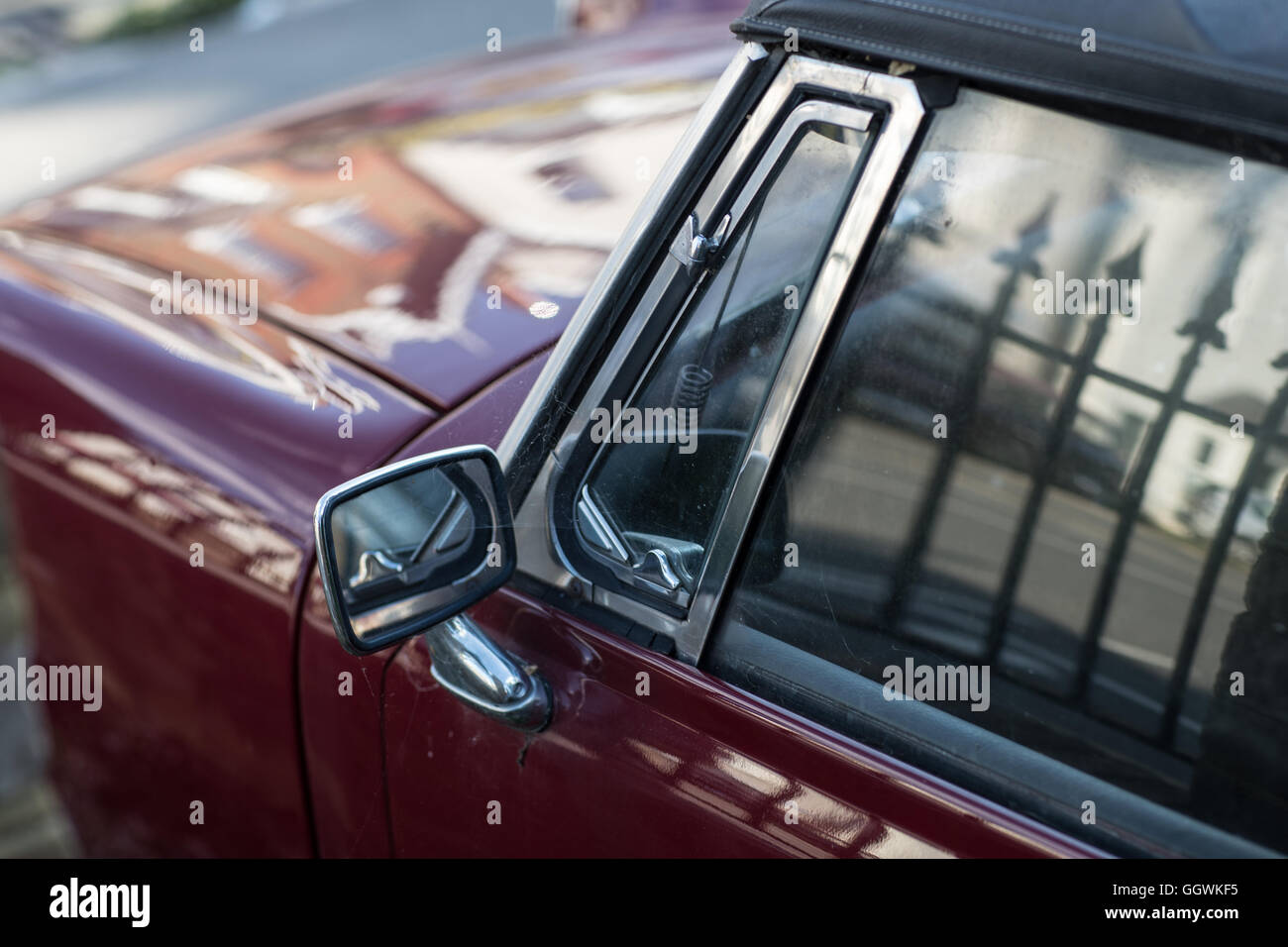 Classic MG vintage car rear view mirror and window reflection. London