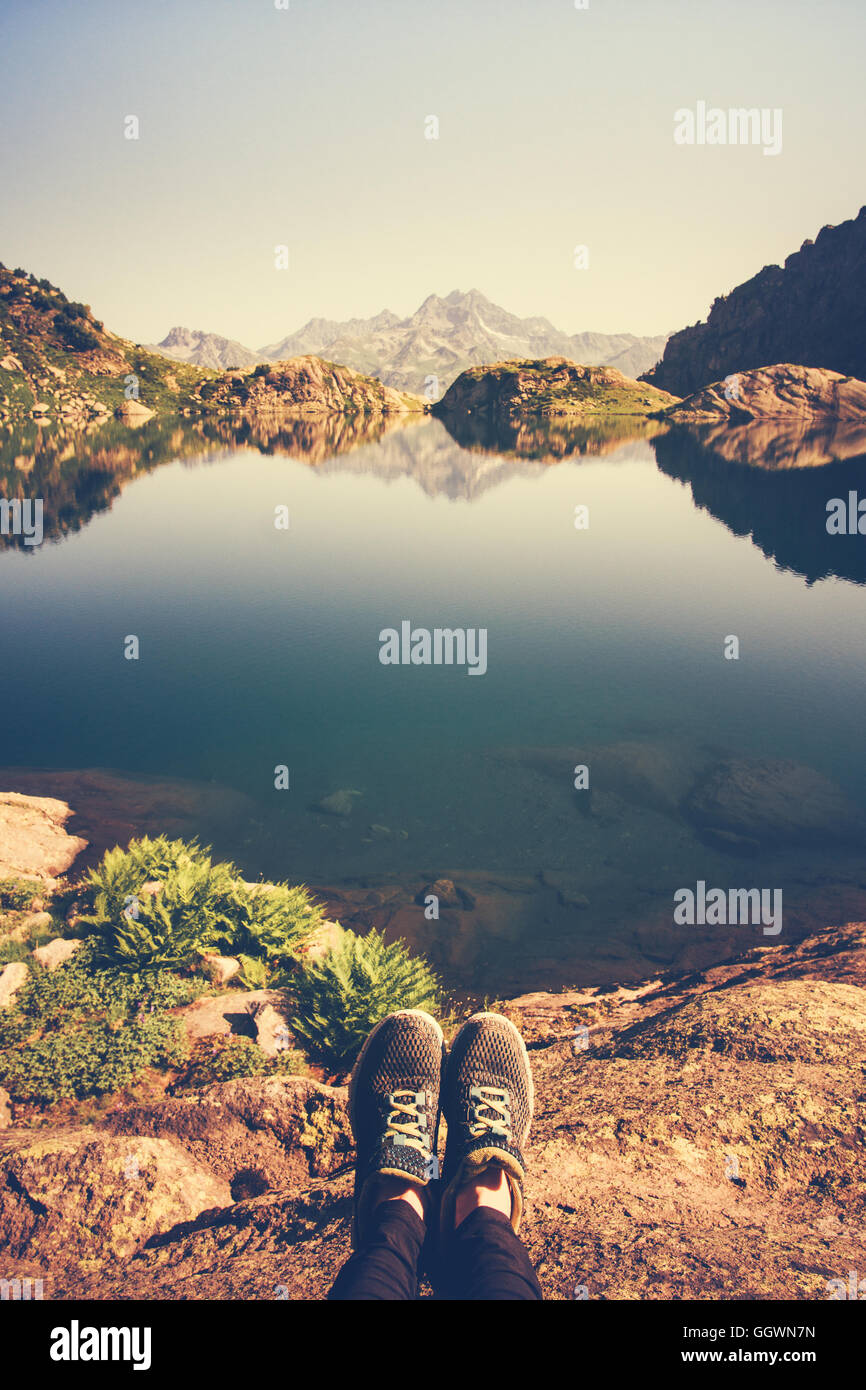 Feet Selfie Traveler relaxing with lake and mountains view on background Lifestyle hiking Travel concept summer vacations advent Stock Photo