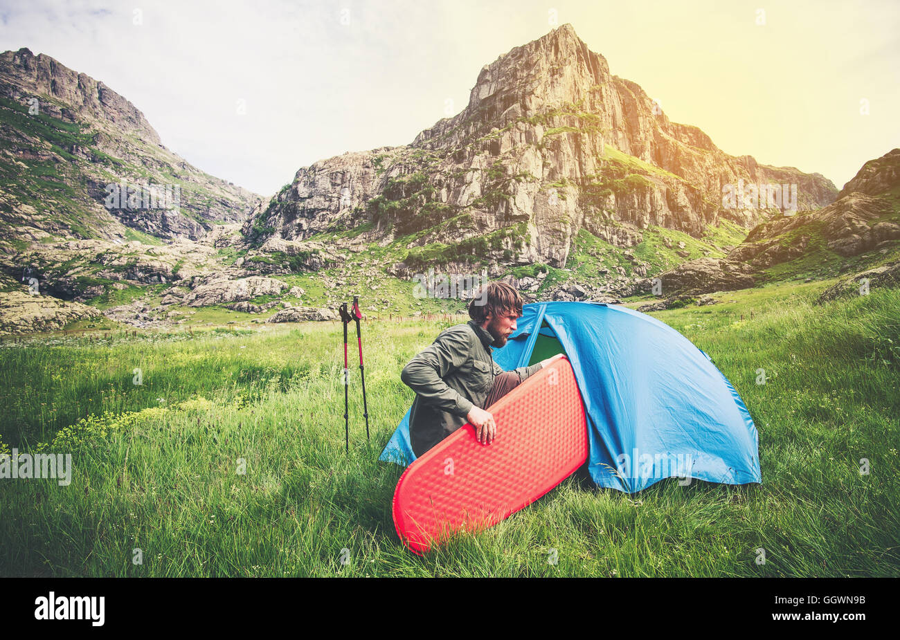 Man Traveler with camping equipment mattress and tent outdoor Travel ...